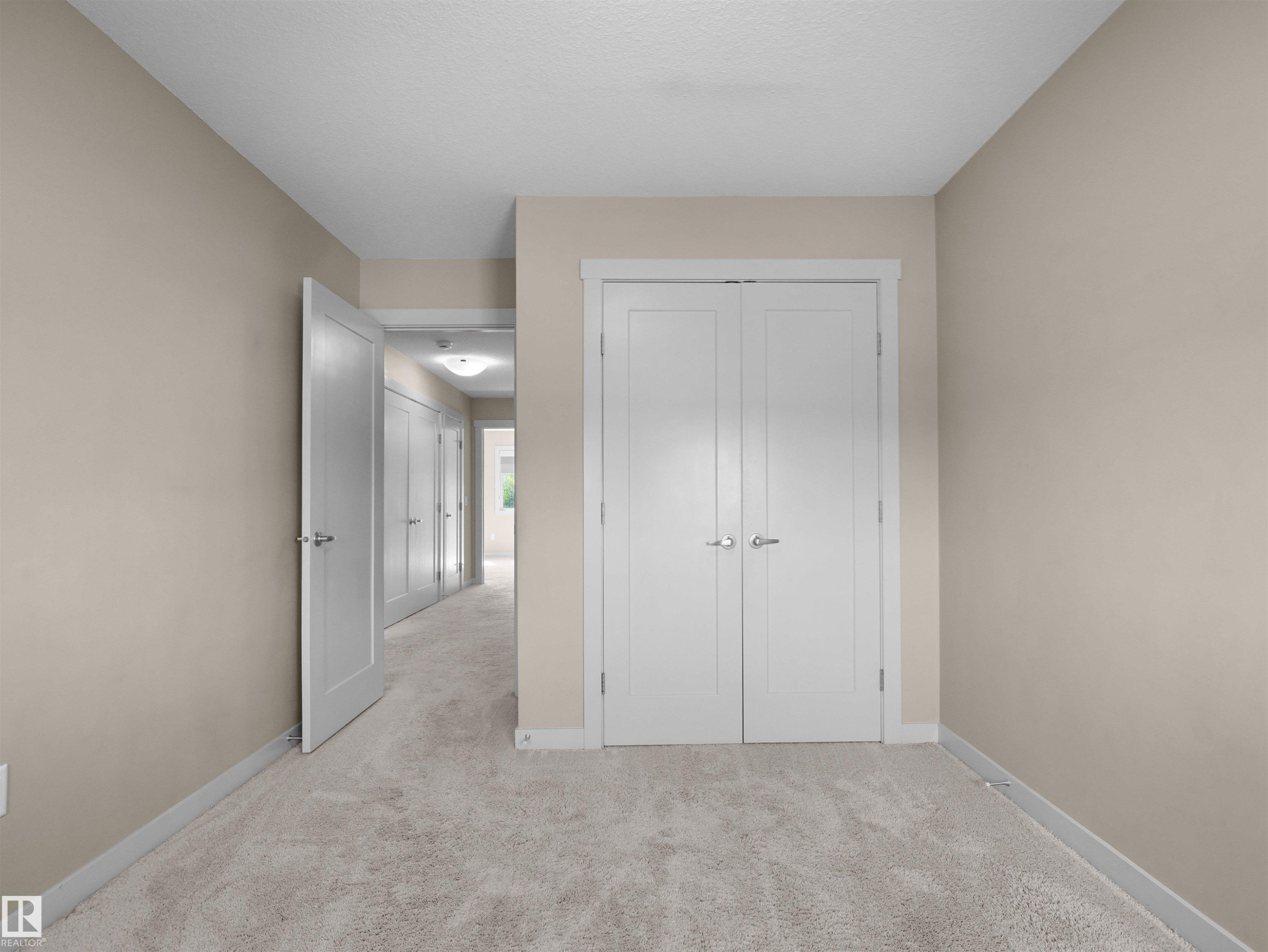Plush carpeted flooring and neutral wall tones - 4487 Annett Common Sw, Edmonton, AB - Indoor Photo Showing Other Room