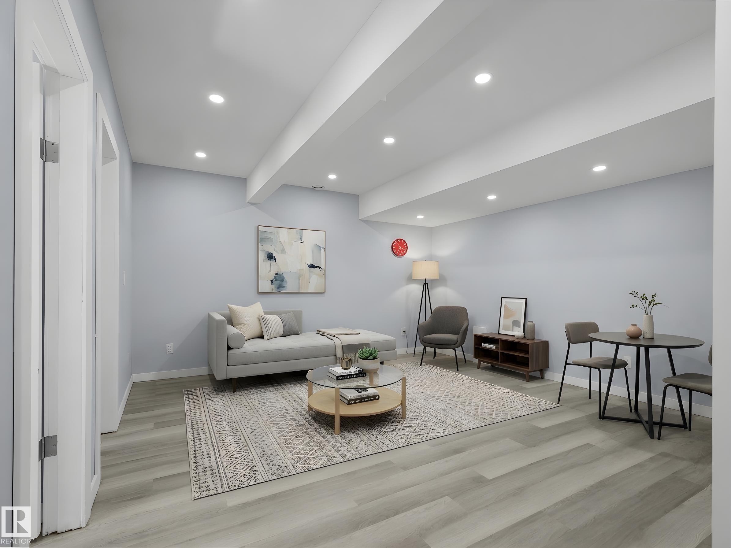 Spacious room with recessed lighting, light wood-finish flooring, light blue wall paint, and white trim - 4487 Annett Common Sw, Edmonton, AB - Indoor