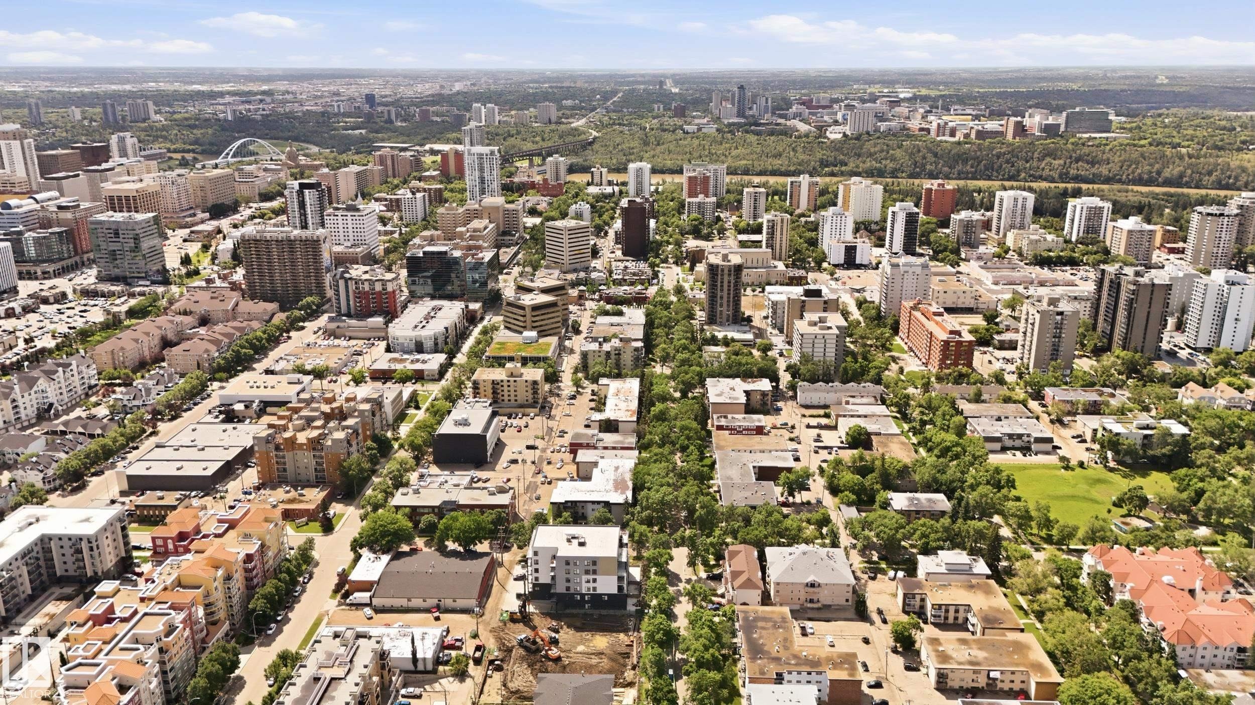 Aerial perspective showcasing a vibrant urban landscape with diverse architectural styles, including multi-story residential buildings and commercial structures - #433 11217 103 Av Nw, Edmonton, AB - Outdoor With View