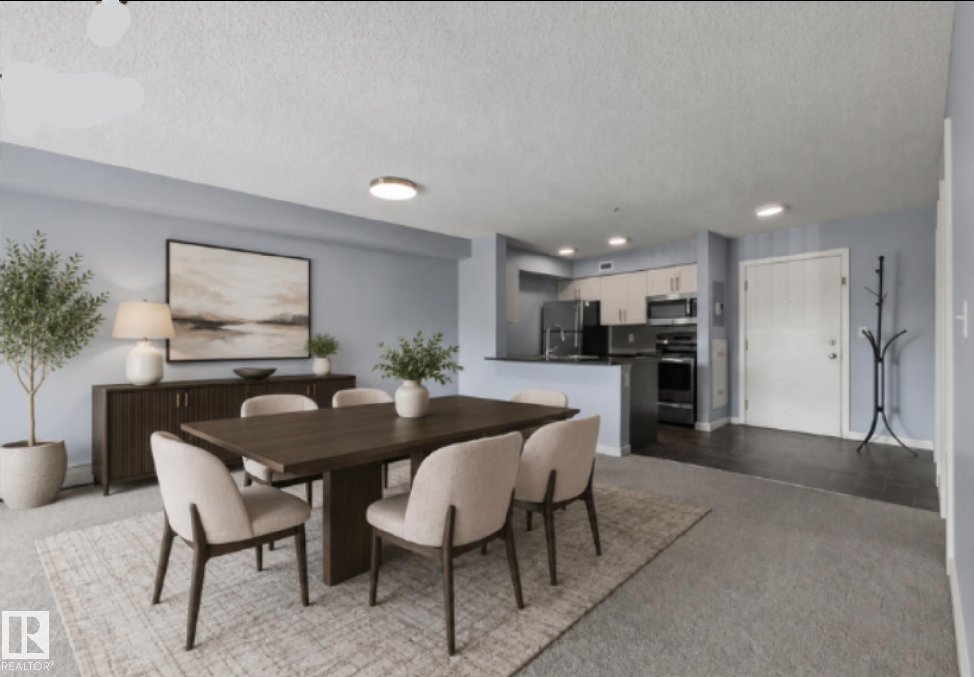 Open-concept living and dining area featuring a wood-finish dining table, neutral upholstered seating, recessed ceiling lighting, and large-scale artwork - #217 12045 22 Av Sw, Edmonton, AB - Indoor Photo Showing Dining Room