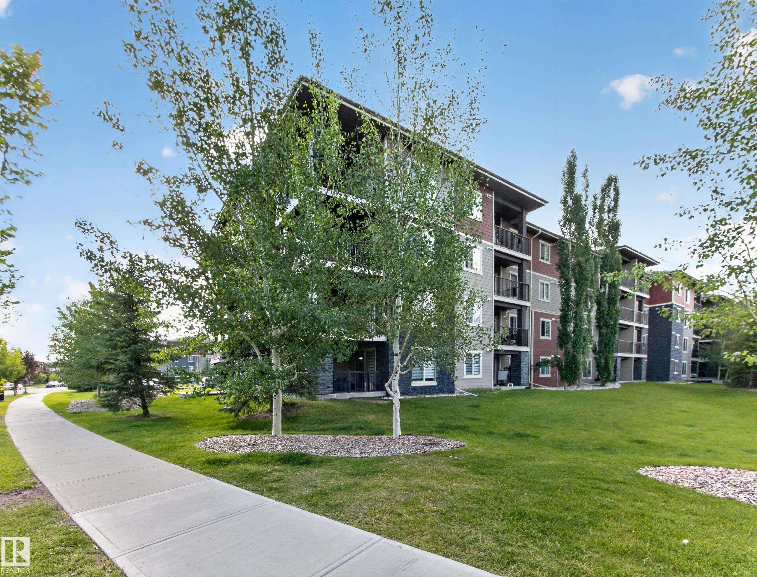 Multi-story residential building with contemporary siding and stone accents - #217 12045 22 Av Sw, Edmonton, AB - Outdoor