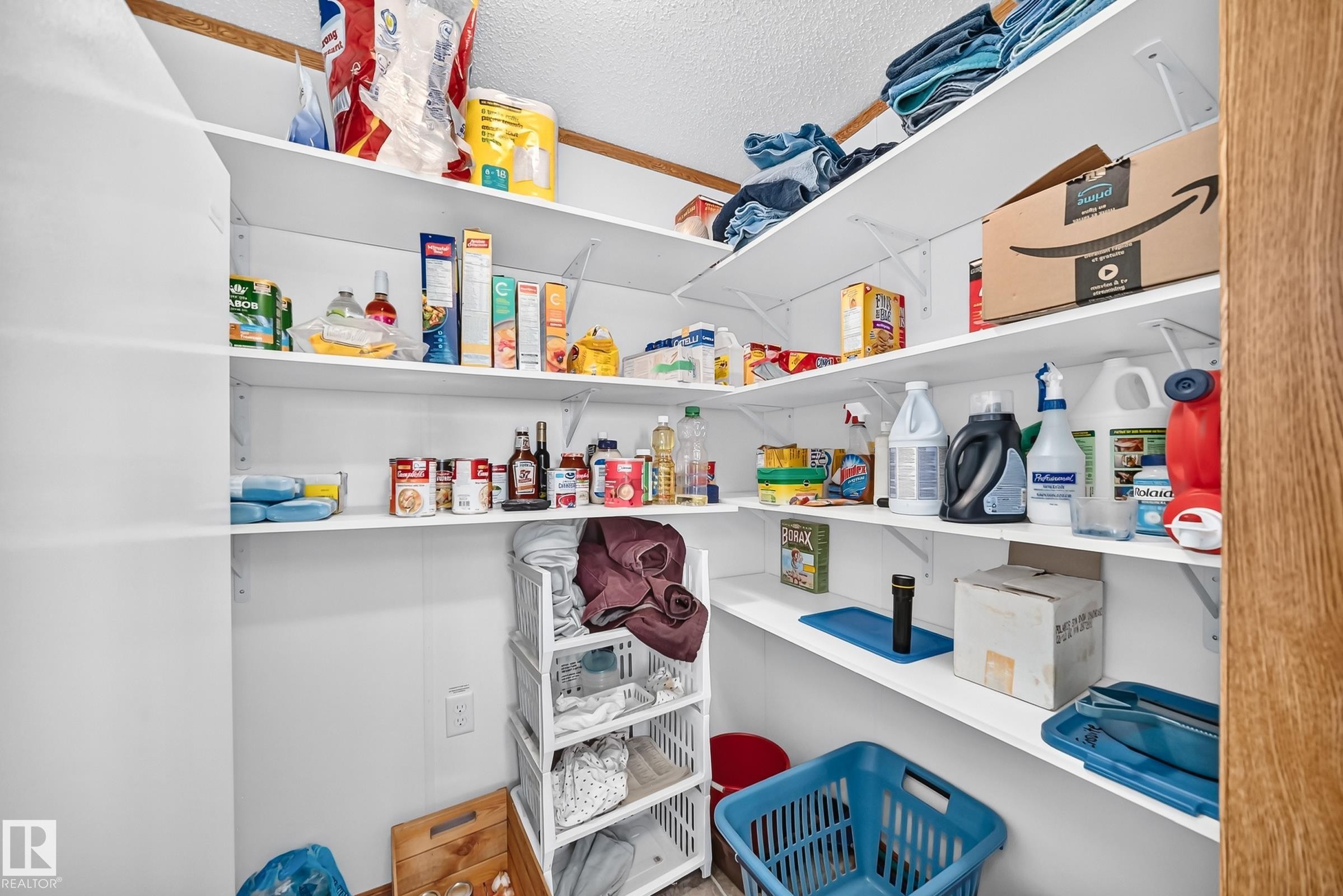 Walk-in pantry featuring white shelving, white walls, and wood-finish trim - #225 3400 48 St, Stony Plain, AB - Indoor With Storage