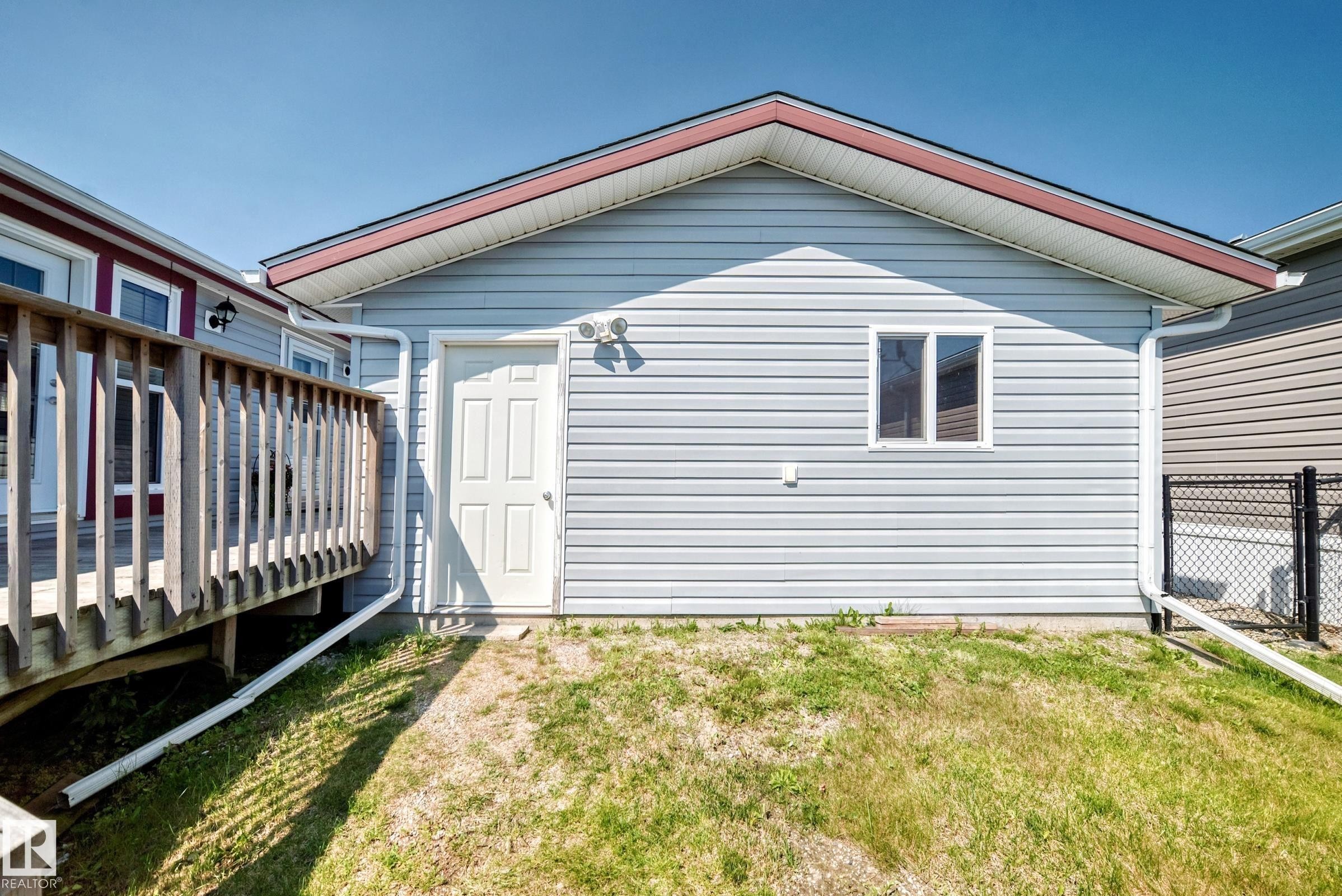 Detached structure with horizontal siding, a side entry door, and a single window - #225 3400 48 St, Stony Plain, AB - Outdoor With Exterior