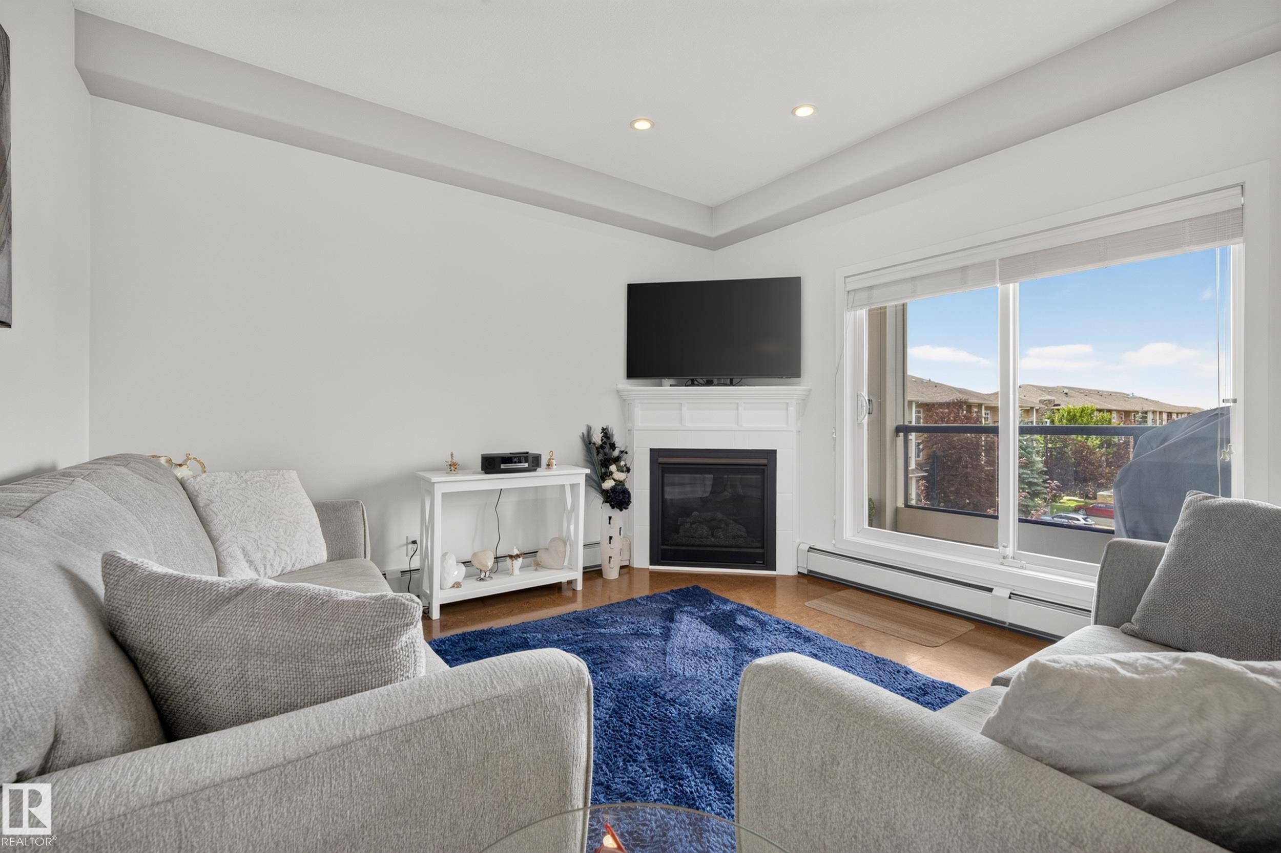 #465 11517 Ellerslie Rd Sw, Edmonton, AB - Indoor Photo Showing Living Room With Fireplace