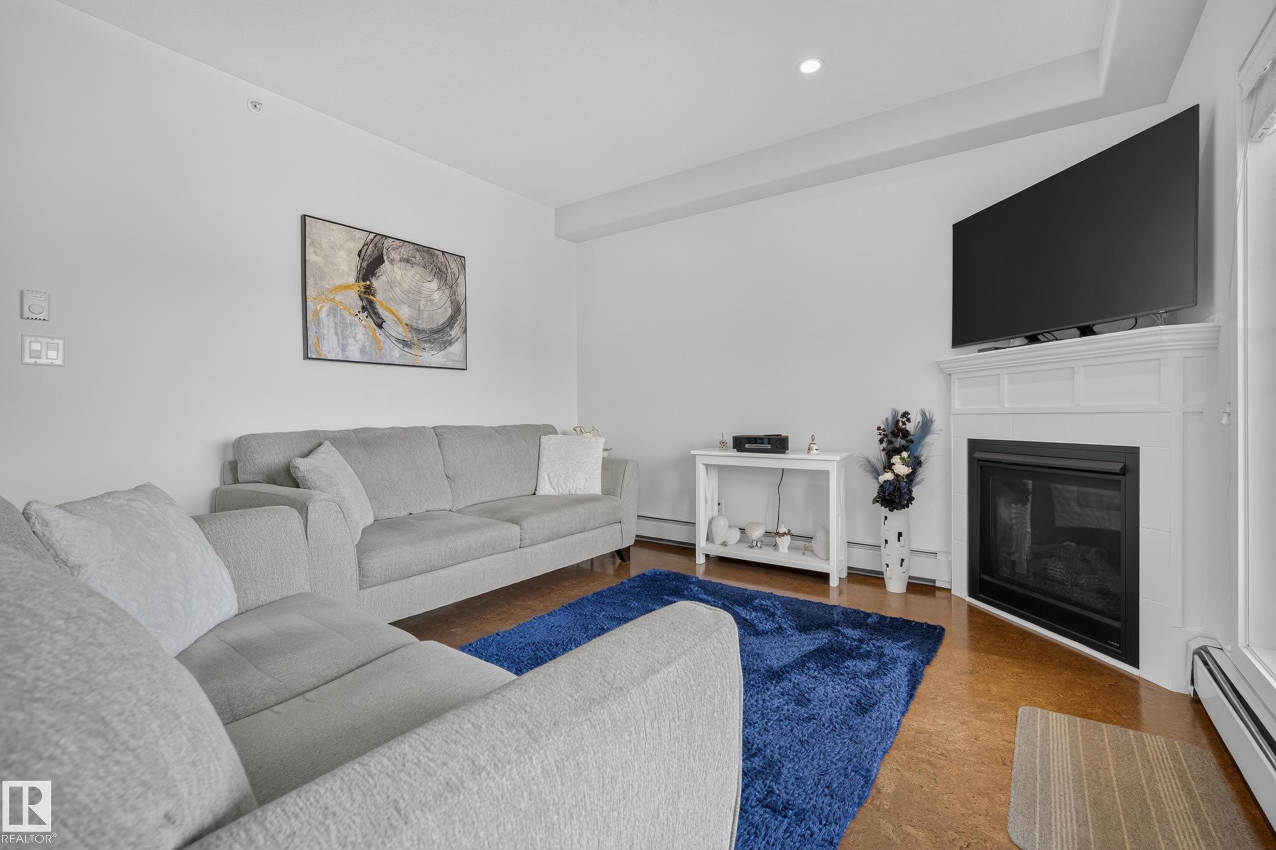 #465 11517 Ellerslie Rd Sw, Edmonton, AB - Indoor Photo Showing Living Room With Fireplace