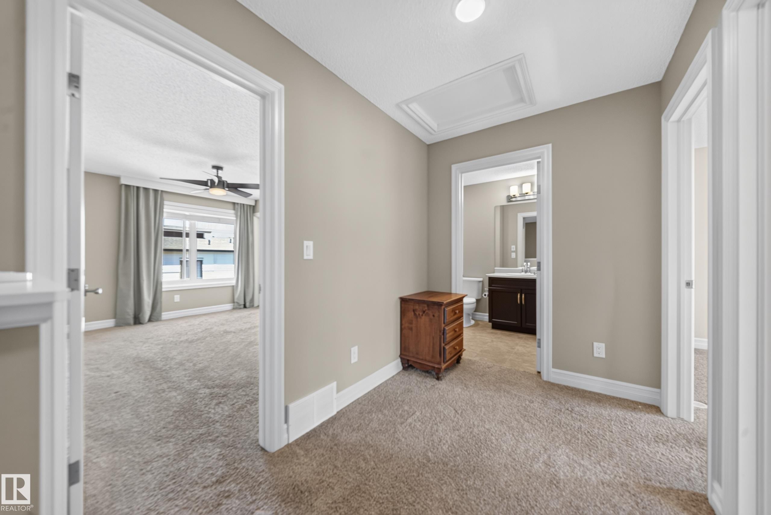 Carpeted hallway with neutral wall paint and white trim - #100 804 Welsh Dr Sw, Edmonton, AB - Indoor Photo Showing Other Room