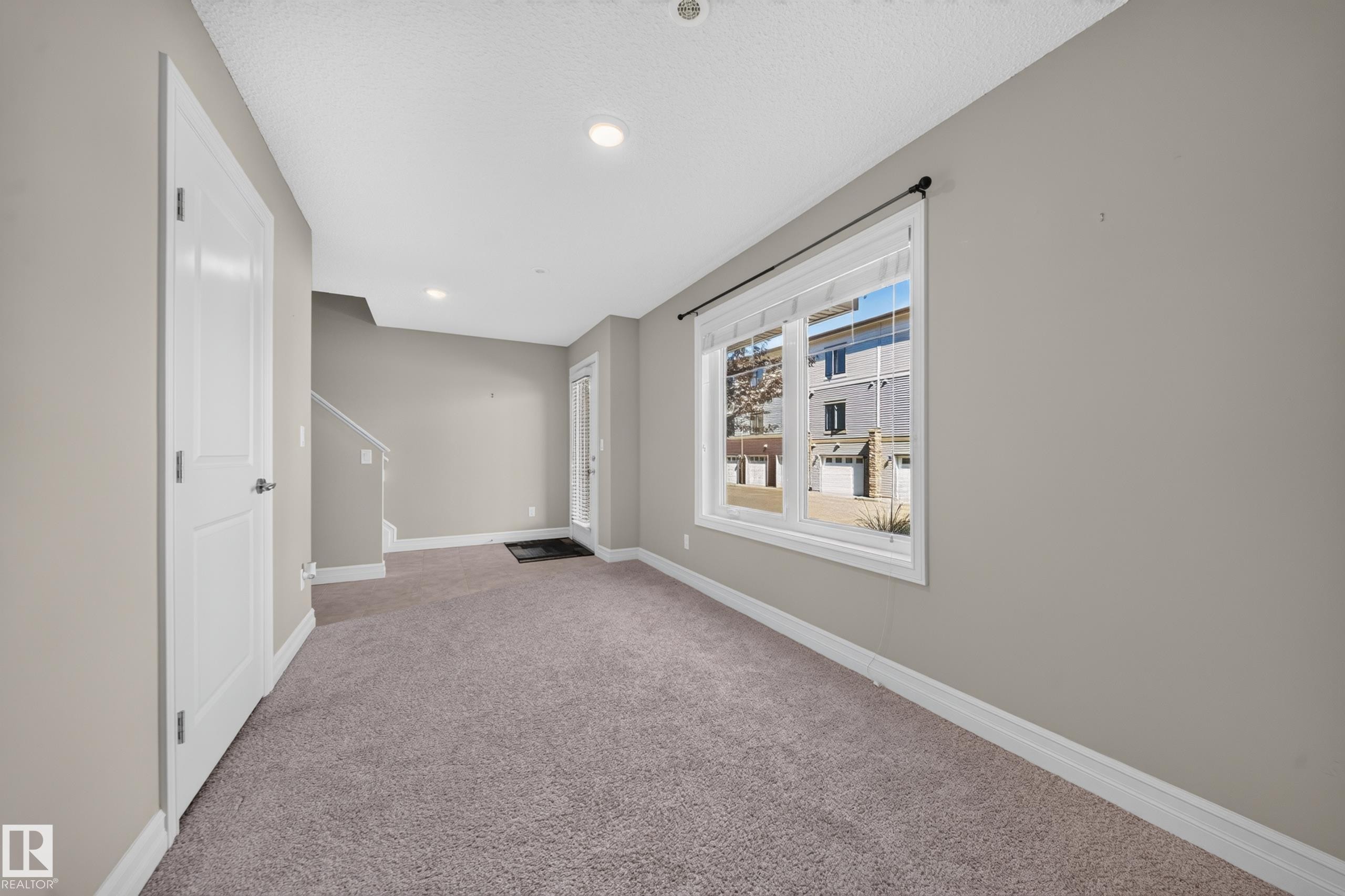 Carpeted room with neutral wall tones and white baseboards - #100 804 Welsh Dr Sw, Edmonton, AB - Indoor Photo Showing Other Room