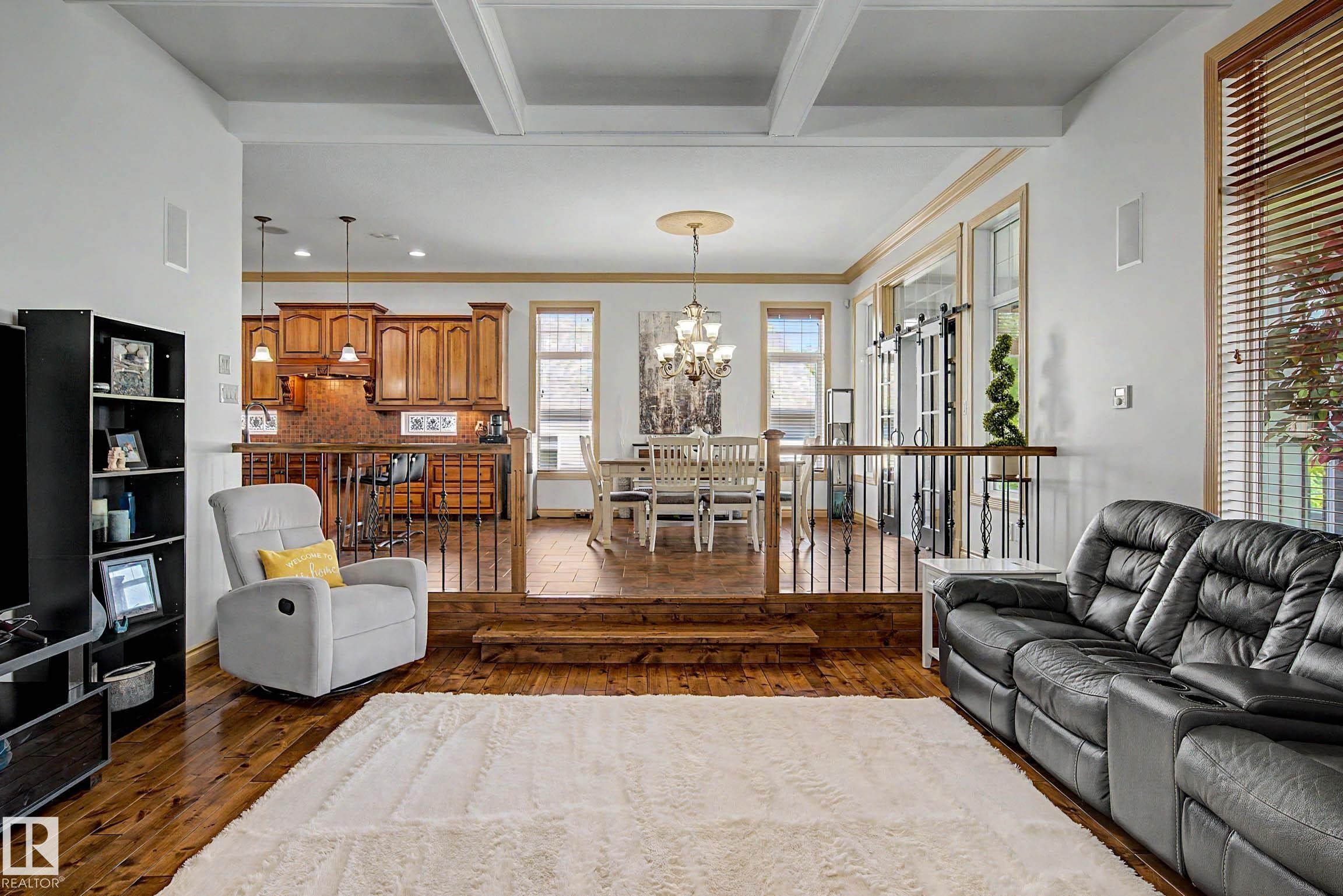 Living area featuring wood-finish flooring and coffered ceilings - 38 Longview Point(E), Spruce Grove, AB - Indoor Photo Showing Living Room