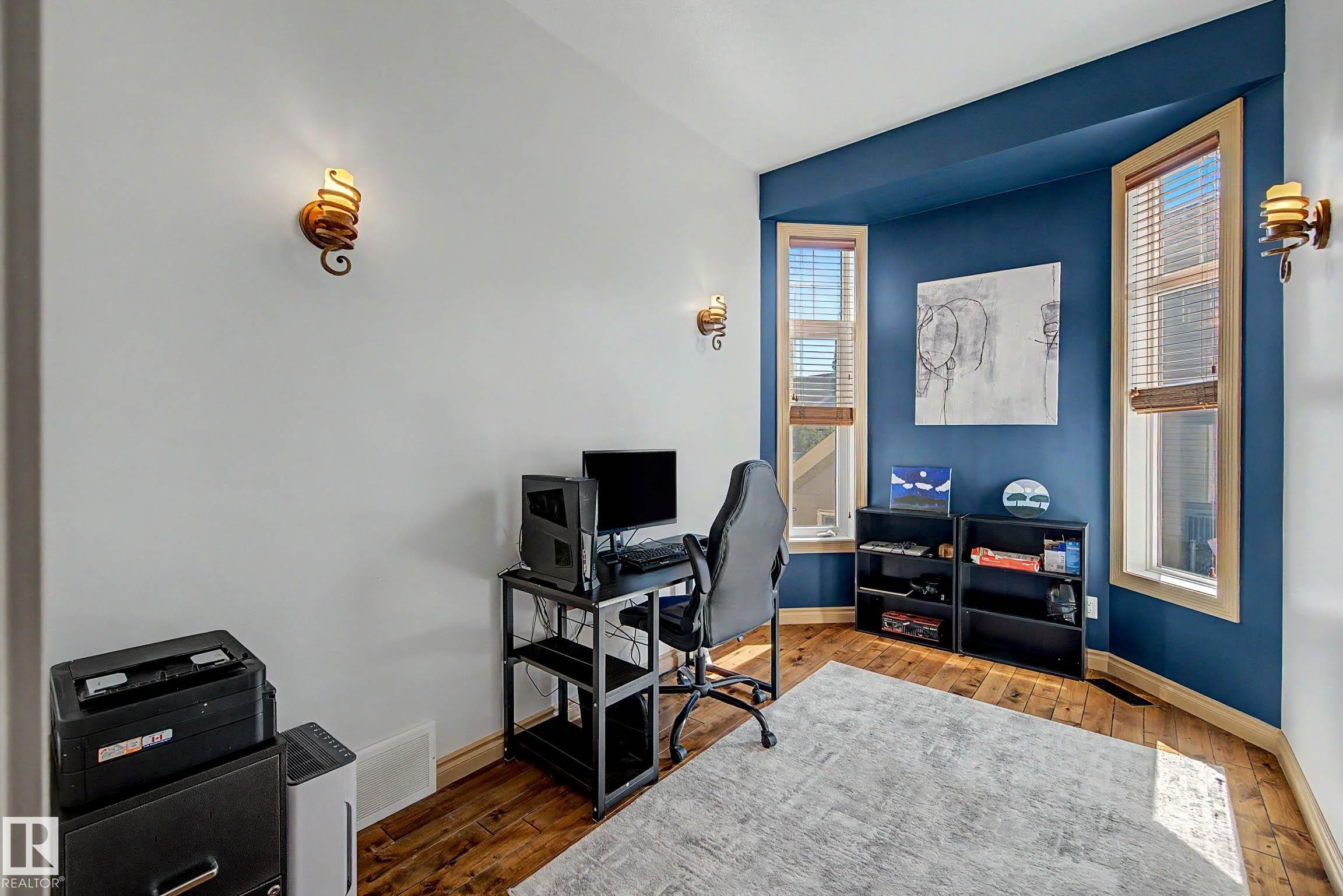 Room featuring light wood-finish flooring and a dedicated accent wall - 38 Longview Point(E), Spruce Grove, AB - Indoor