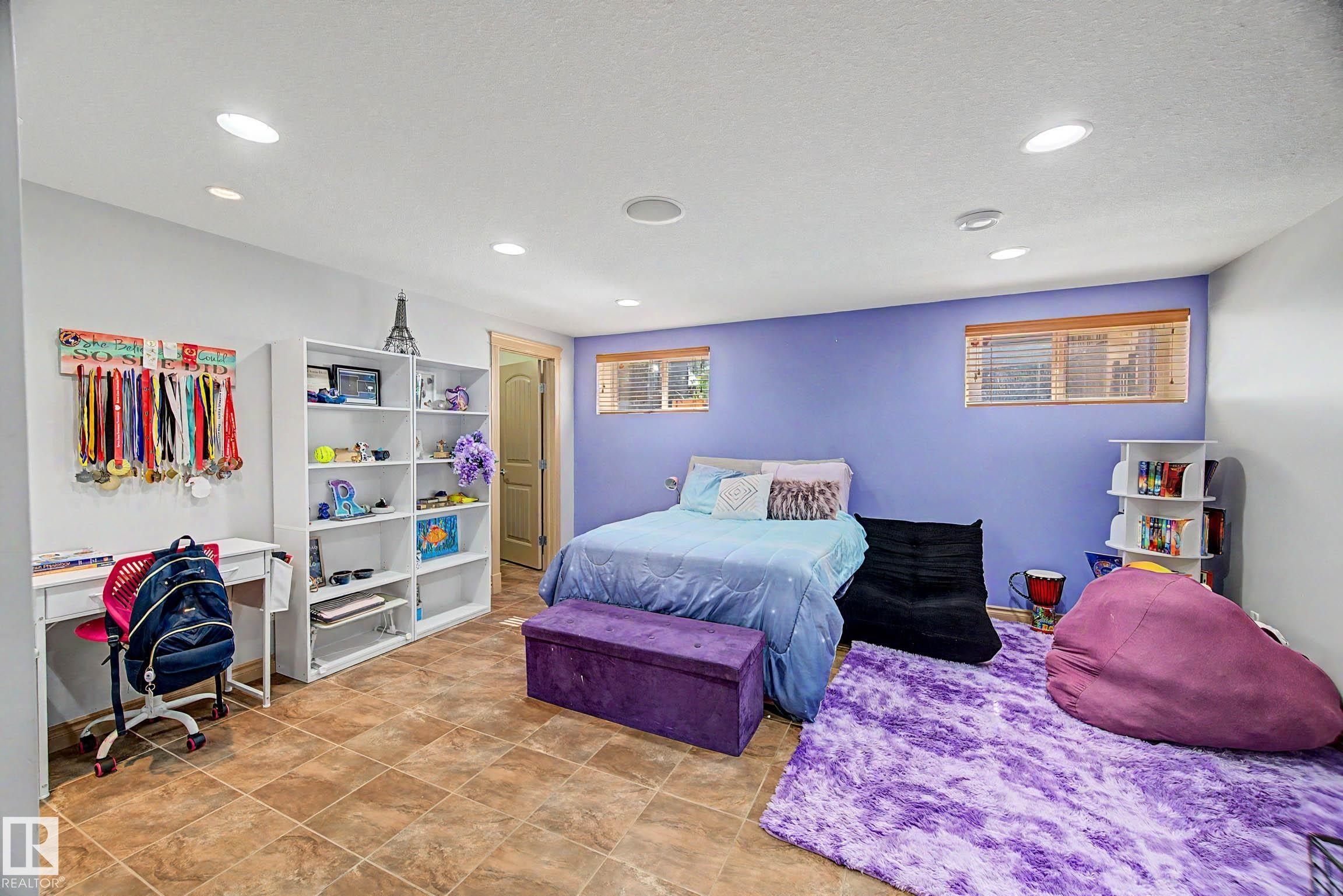 Spacious room with recessed lighting, tile flooring, and integrated shelving - 38 Longview Point(E), Spruce Grove, AB - Indoor Photo Showing Bedroom