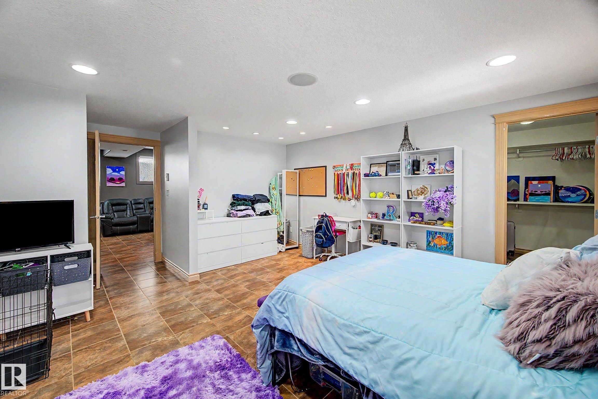Spacious room featuring neutral paint, recessed lighting, and tile flooring - 38 Longview Point(E), Spruce Grove, AB - Indoor Photo Showing Bedroom