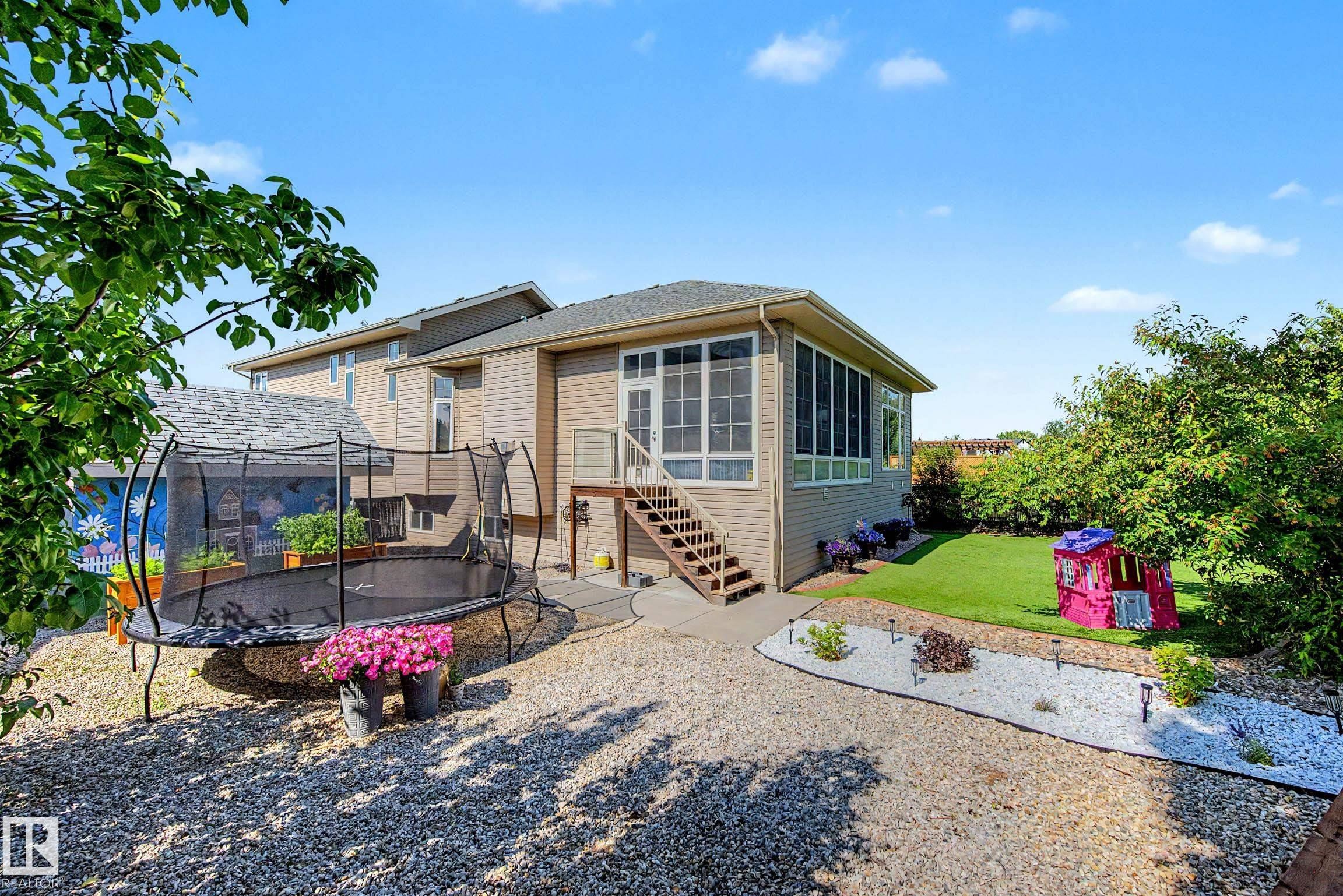 Rear exterior with a screened-in porch and exterior staircase - 38 Longview Point(E), Spruce Grove, AB - Outdoor With Deck Patio Veranda