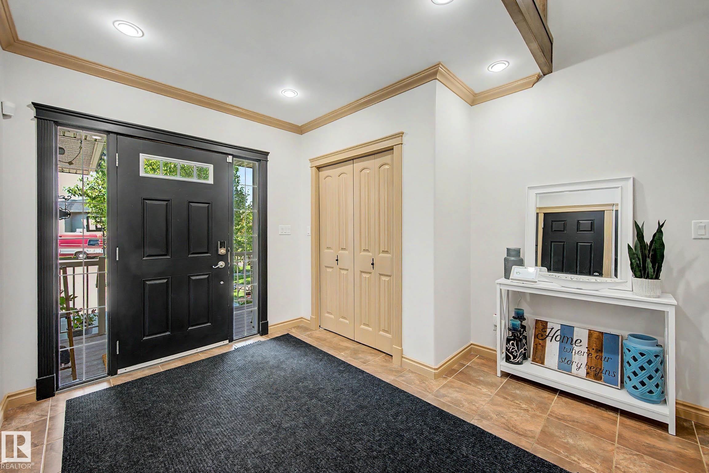 Entryway featuring a black paneled door with sidelights and transom window, recessed lighting, wood-finish flooring, and light wood trim - 38 Longview Point(E), Spruce Grove, AB - Indoor Photo Showing Other Room
