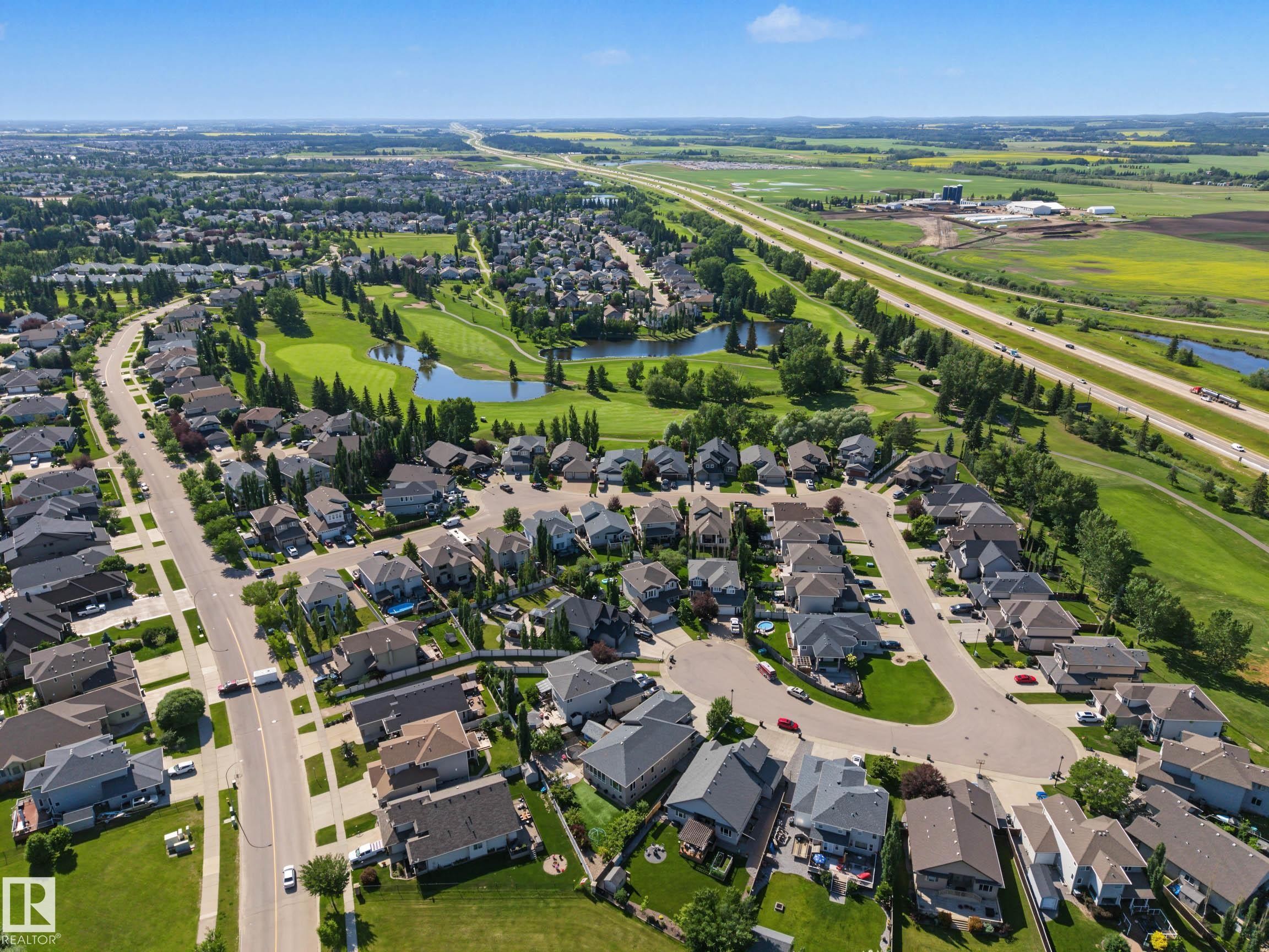 Aerial perspective showcasing a residential development with varied housing styles - 38 Longview Point(E), Spruce Grove, AB - Outdoor With View