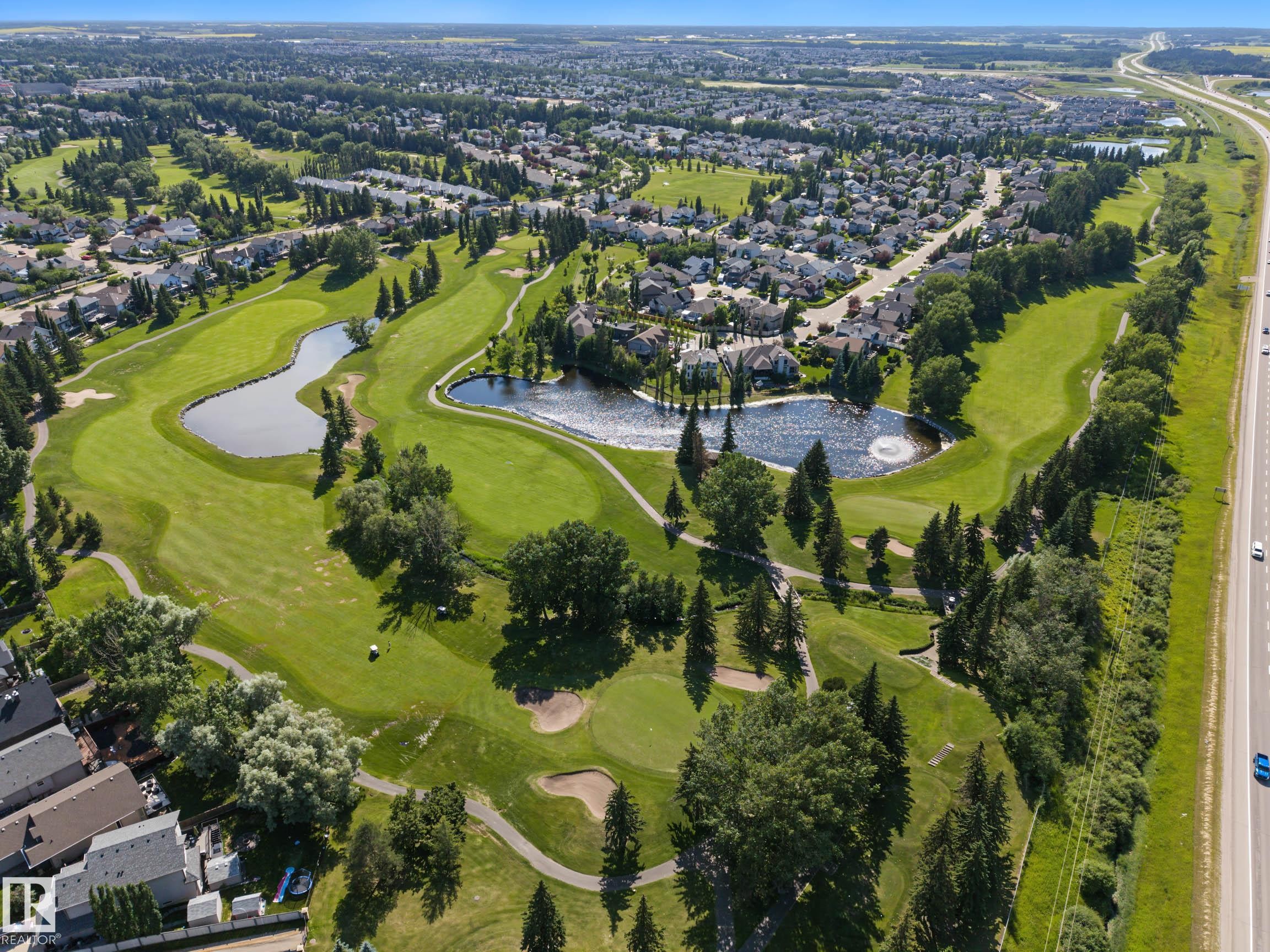Expansive golf course setting featuring multiple greens, fairways, and water features - 38 Longview Point(E), Spruce Grove, AB - Outdoor With View