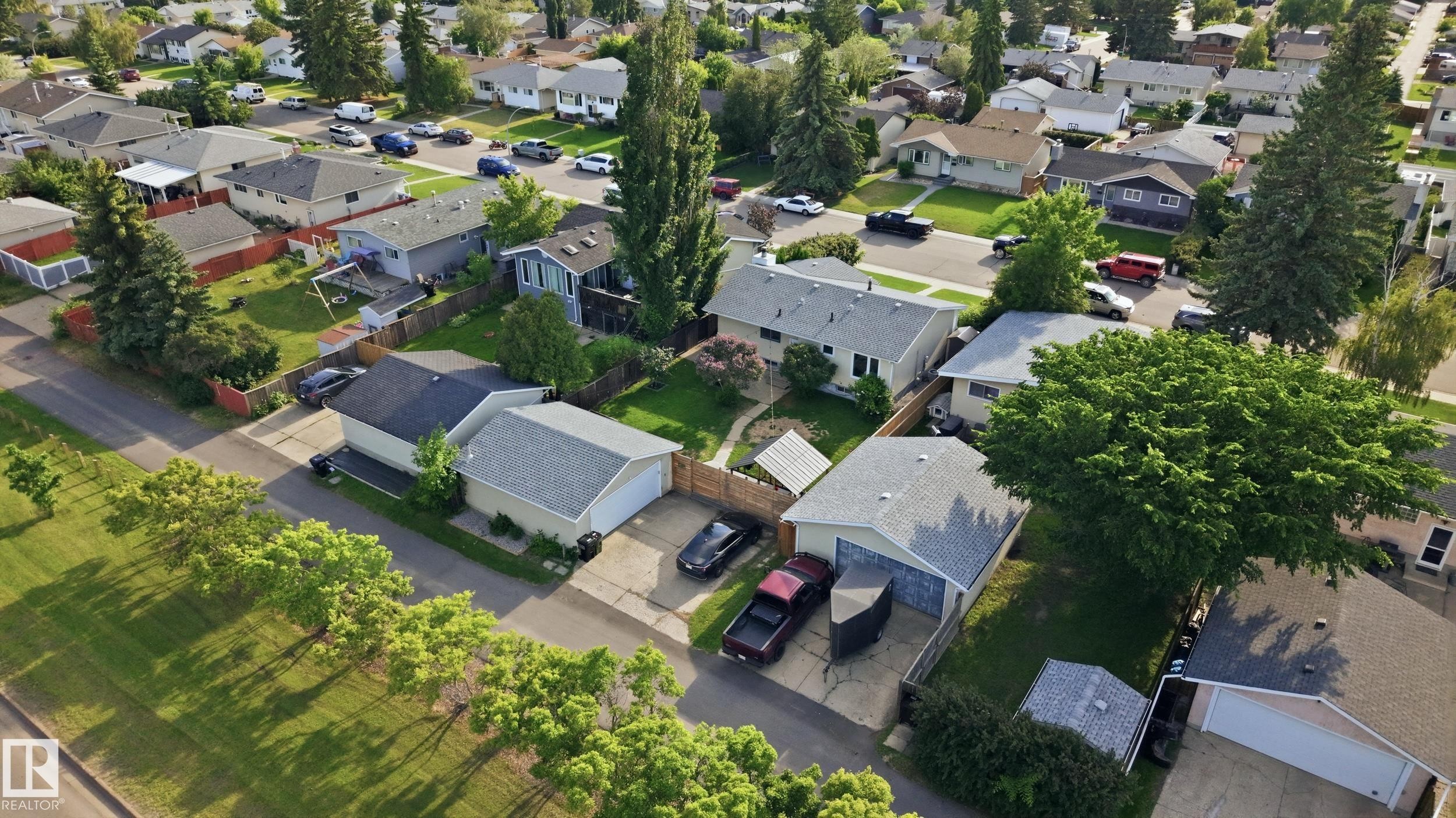 Residential neighborhood showcasing single-family homes with pitched roofs and mature landscaping - 15111 67 Street Nw, Edmonton, AB - Outdoor With View