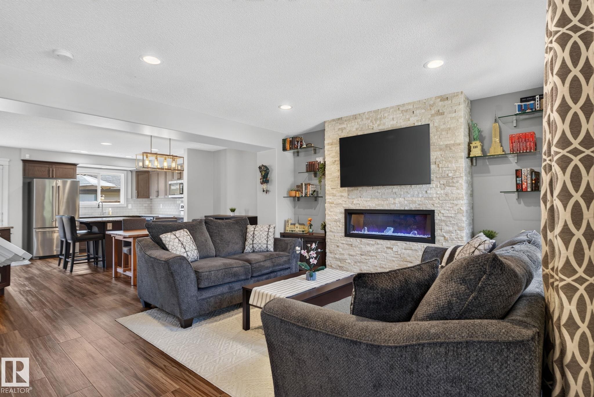 Living room - 319 Desrochers Boulevard Sw, Edmonton, AB - Indoor Photo Showing Living Room With Fireplace