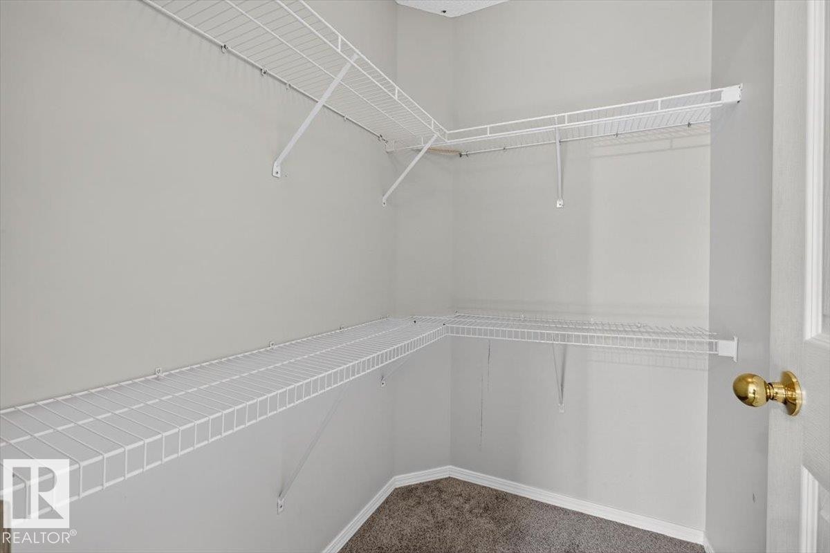 Walk-in closet featuring white wire shelving on multiple walls - #18 345 Kirkness Rd Nw, Edmonton, AB - Indoor With Storage