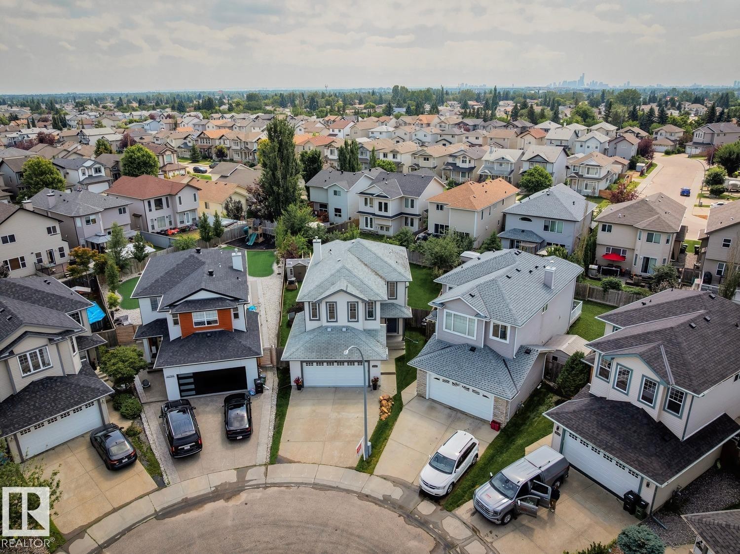 Aerial perspective showcasing a residential neighborhood with varied architectural styles and mature landscaping - 16765 119 Street Nw, Edmonton, AB