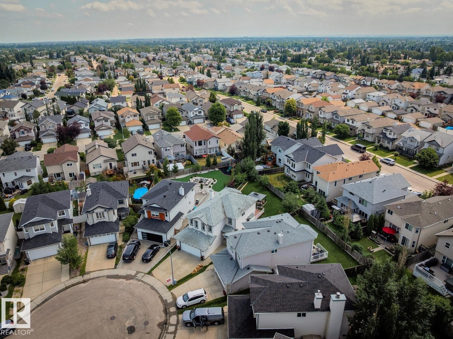 Residential neighborhood with a variety of architectural styles, mature trees, and paved streets - 16765 119 Street Nw, Edmonton, AB