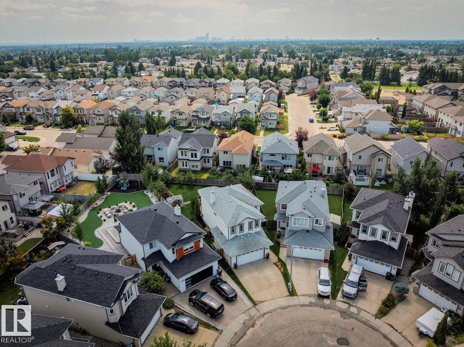 Residential neighborhood with a mix of single-family homes, mature trees, and varying architectural styles - 16765 119 Street Nw, Edmonton, AB