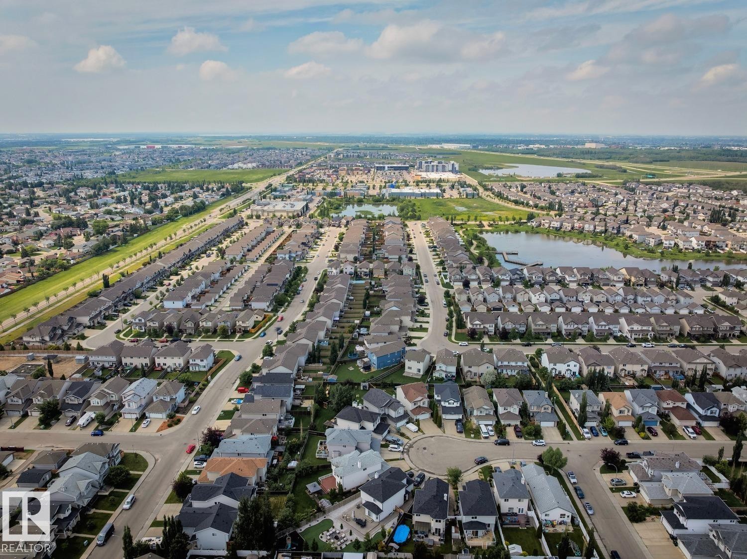 Aerial perspective of a developed residential area featuring numerous single-family homes, roadways, and structured neighborhoods - 16765 119 Street Nw, Edmonton, AB