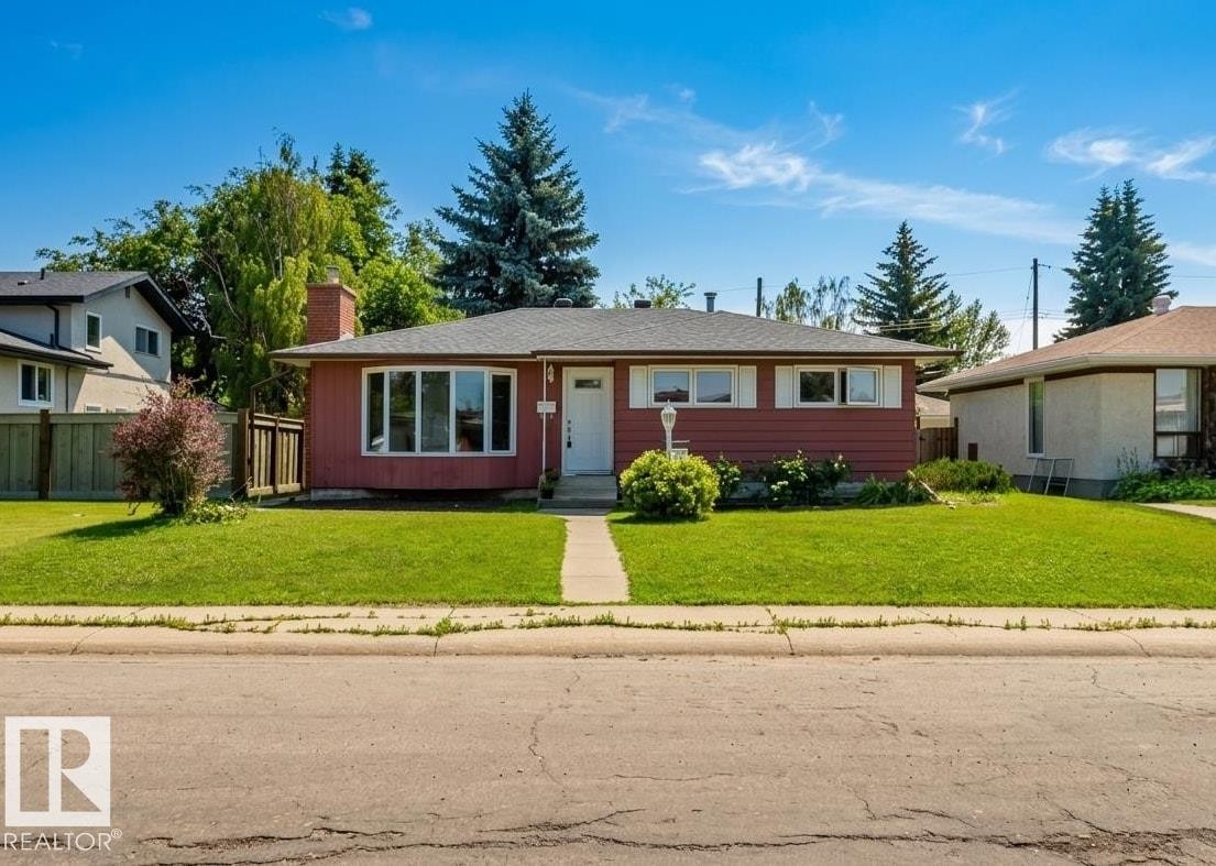 Single-story residence featuring a red siding exterior, white trim, and a prominent front bay window - 11115 39A Avenue Nw, Edmonton, AB - Outdoor With Facade