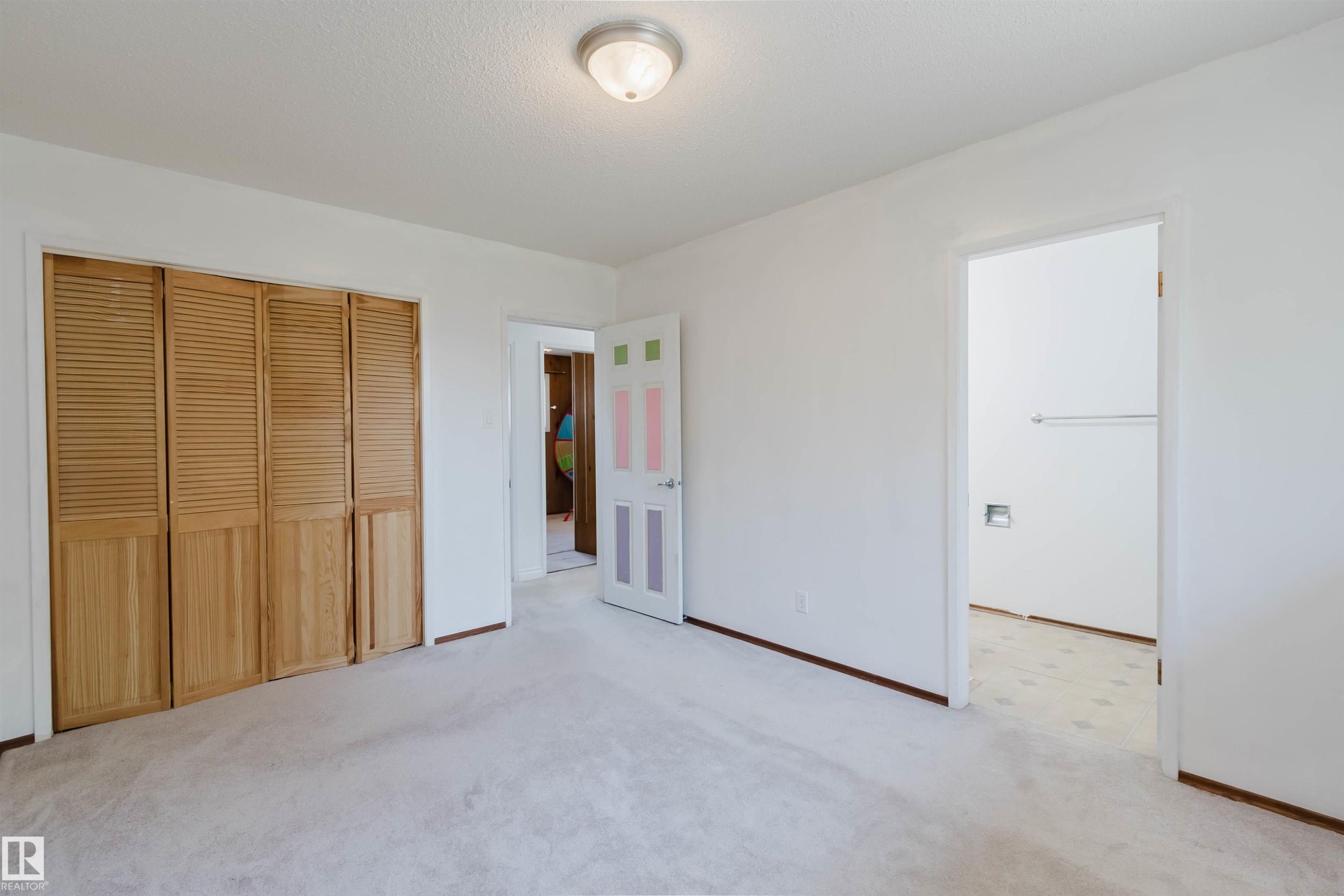 Spacious room with light-toned carpeting and white walls - 11115 39A Avenue Nw, Edmonton, AB - Indoor Photo Showing Other Room