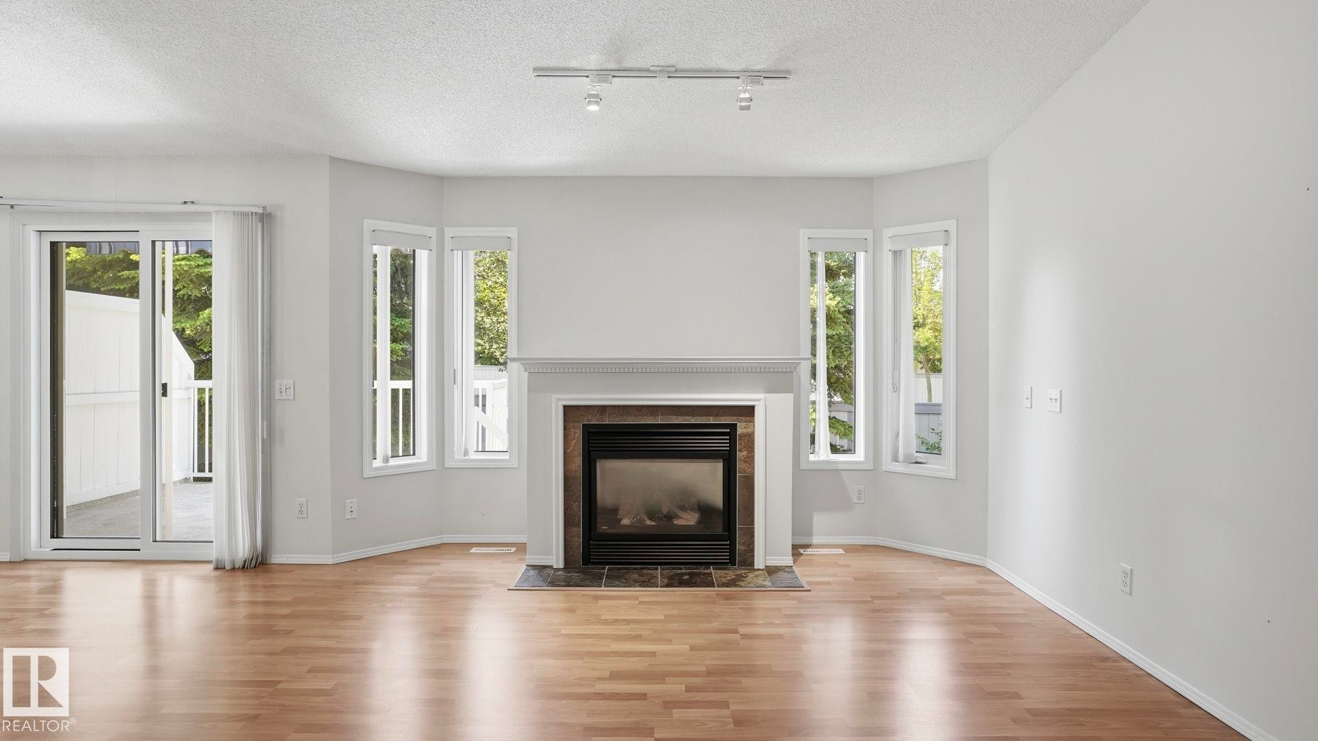 #31 8 Dechene Rd Nw, Edmonton, AB - Indoor Photo Showing Living Room With Fireplace