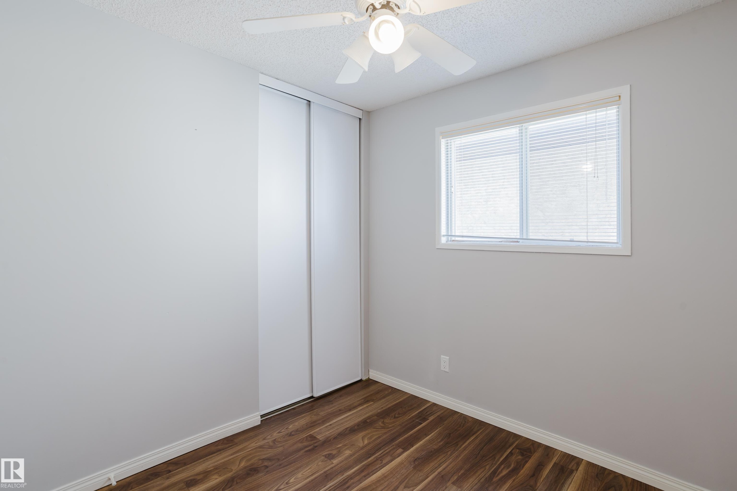 Bedroom featuring wood-finish flooring, white baseboards, and light gray walls - 337 Pearson Crescent Nw, Edmonton, AB - Indoor Photo Showing Other Room