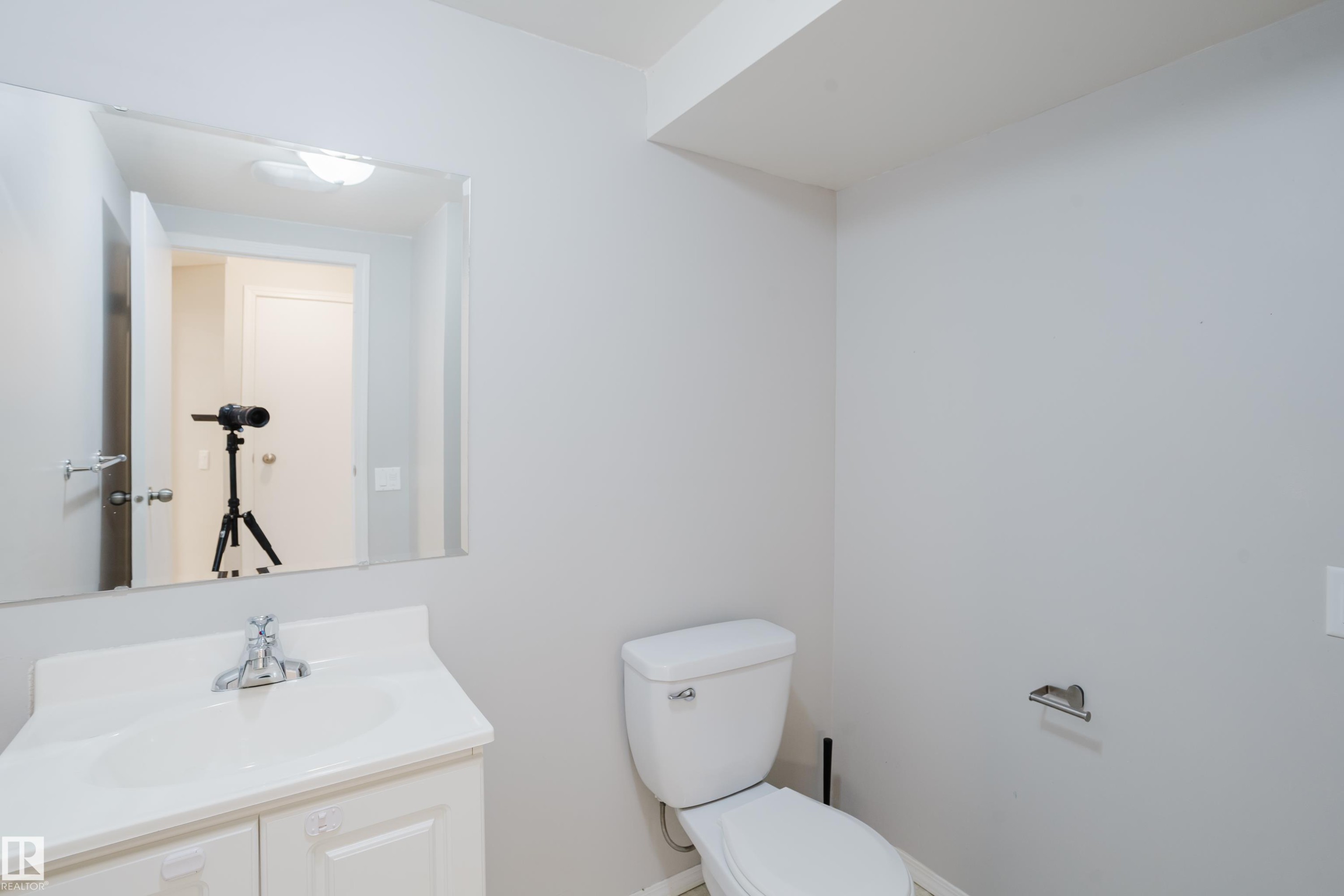 White vanity with integrated sink, chrome faucet, and a wall-mounted mirror - 337 Pearson Crescent Nw, Edmonton, AB - Indoor Photo Showing Bathroom