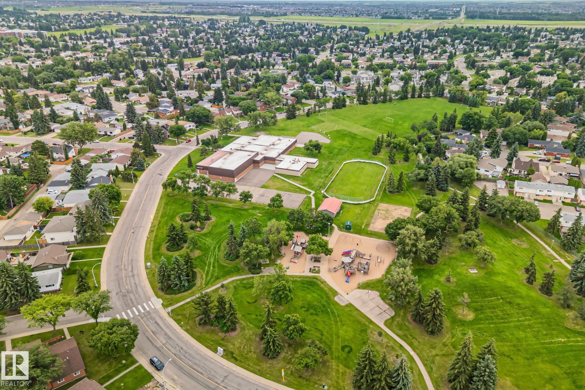 Aerial perspective showcasing a residential area with extensive green spaces - 7306 21 Avenue Nw, Edmonton, AB - Outdoor With View