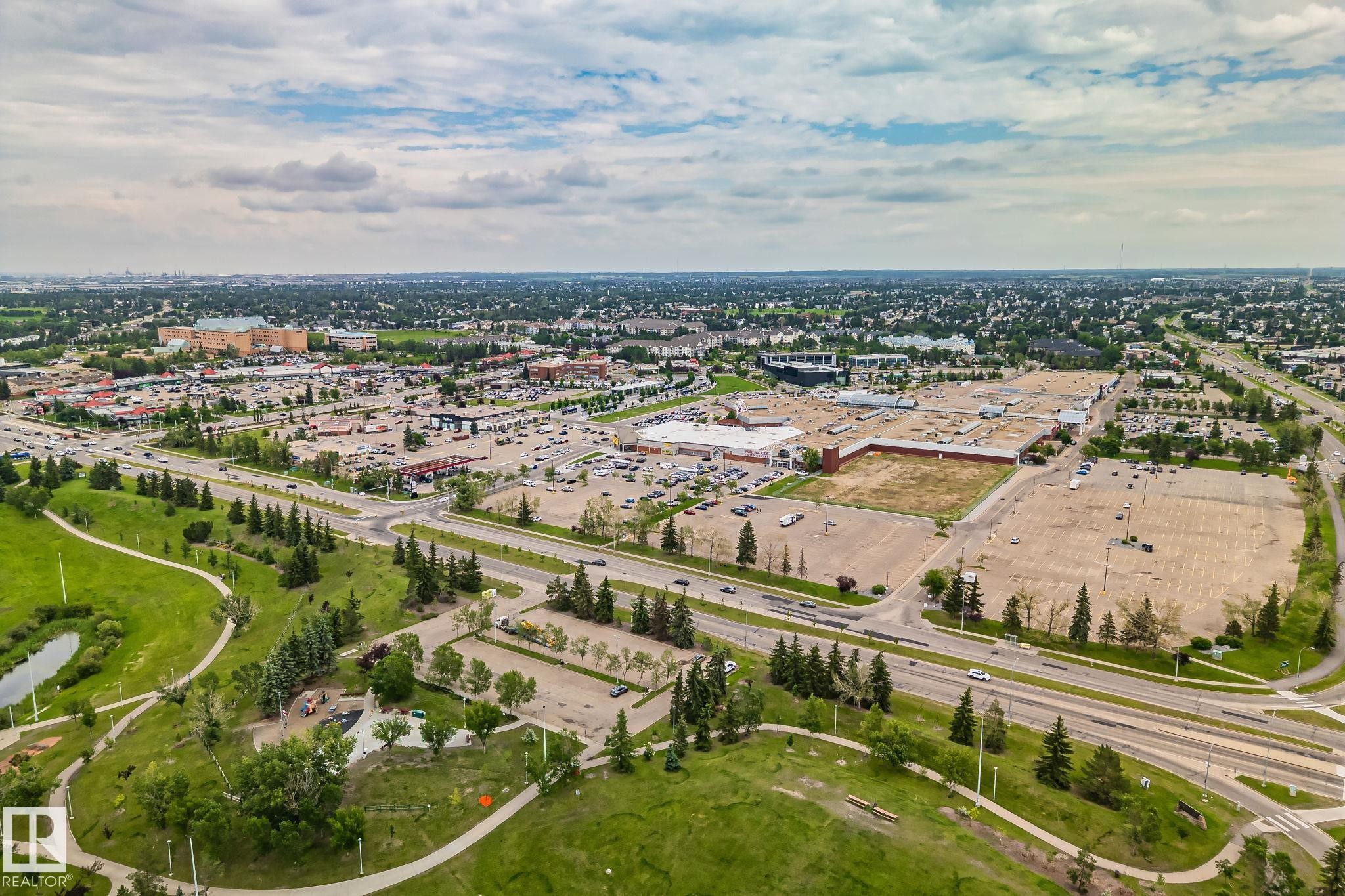 Expansive aerial showcasing a retail district with multiple commercial structures and extensive paved parking areas - 7306 21 Avenue Nw, Edmonton, AB - Outdoor With View