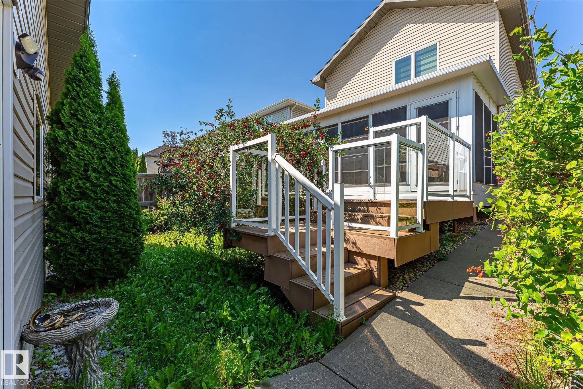 Screened porch with composite decking and white railings - 4317 152 Avenue Nw, Edmonton, AB - Outdoor With Deck Patio Veranda With Exterior