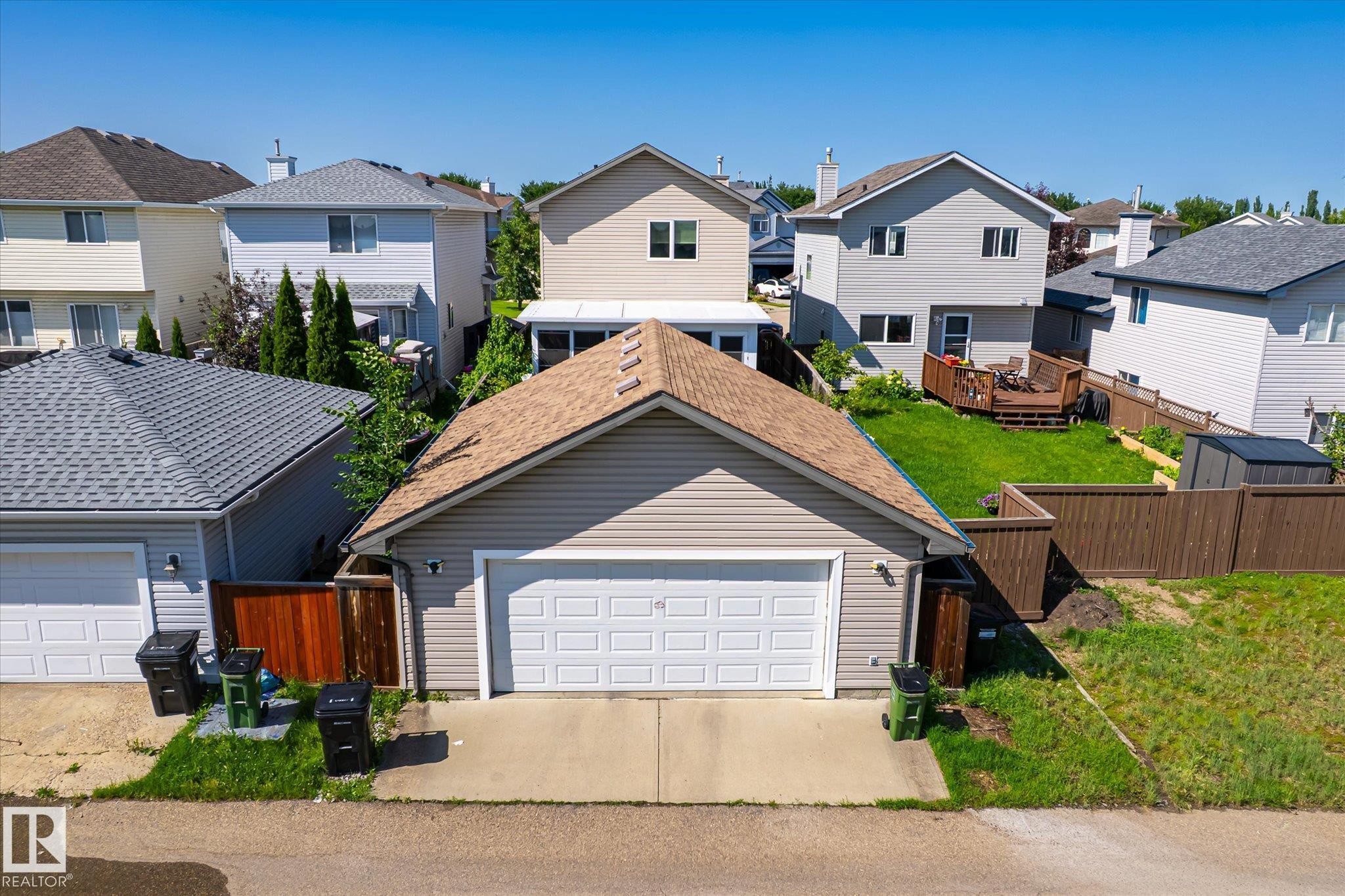 Detached two-car garage with light-colored siding and a brown shingled roof - 4317 152 Avenue Nw, Edmonton, AB - Outdoor