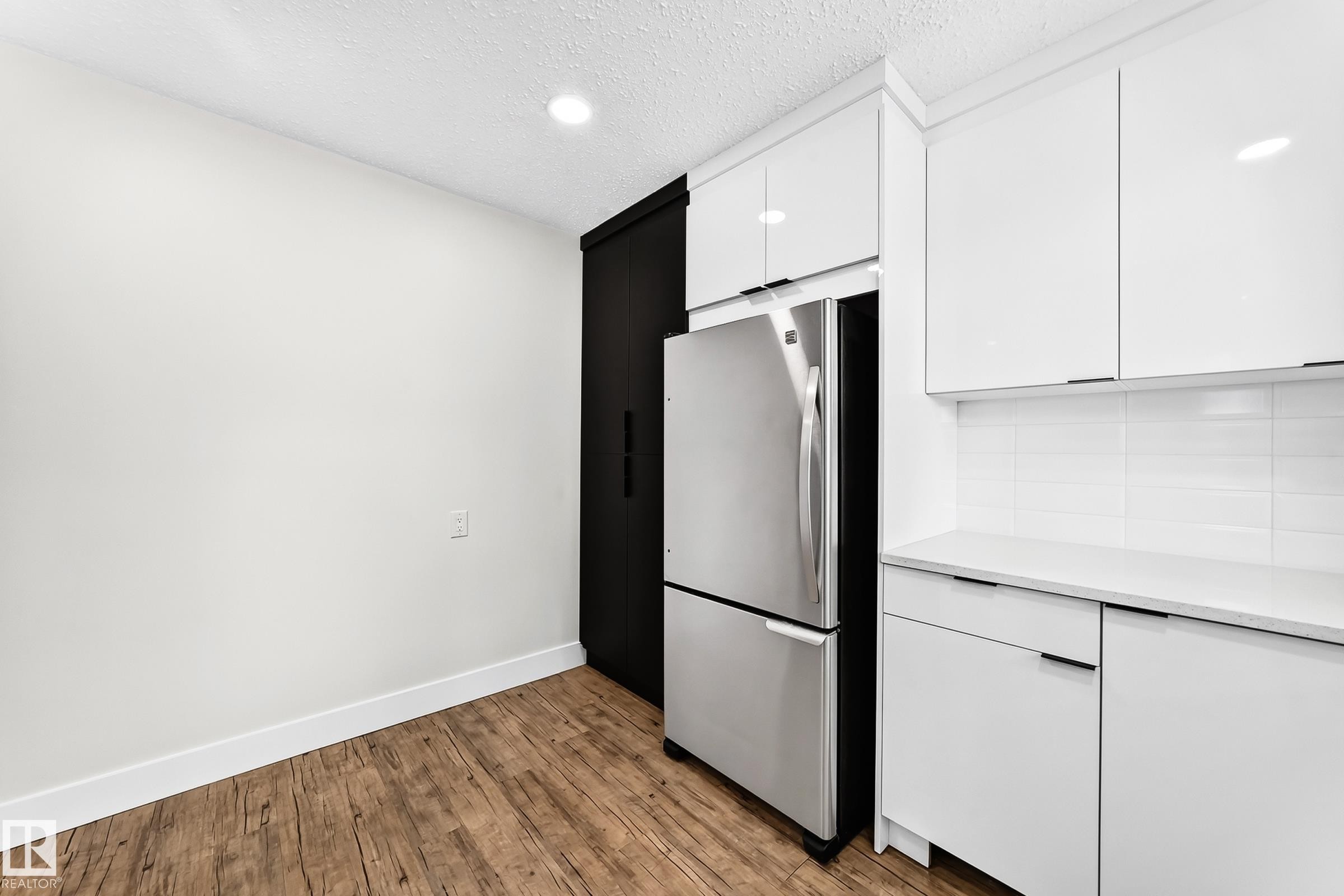 Kitchen featuring wood-finish flooring and recessed lighting - 3119 144 Avenue Nw, Edmonton, AB - Indoor Photo Showing Other Room