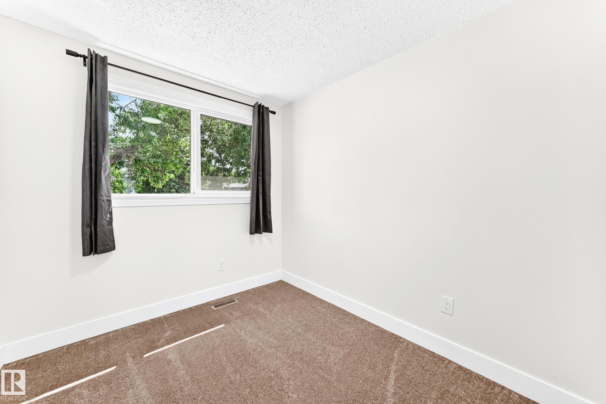 White-painted room featuring a double-paned window with dark drapery - 3119 144 Avenue Nw, Edmonton, AB - Indoor Photo Showing Other Room