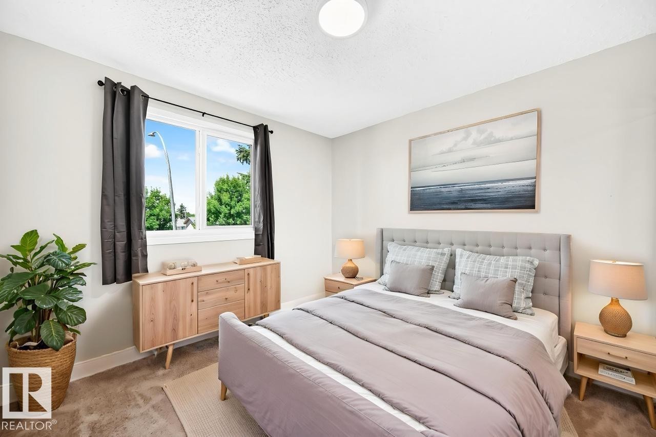 Spacious bedroom featuring light neutral walls and textured carpeting - 3119 144 Avenue Nw, Edmonton, AB - Indoor Photo Showing Bedroom