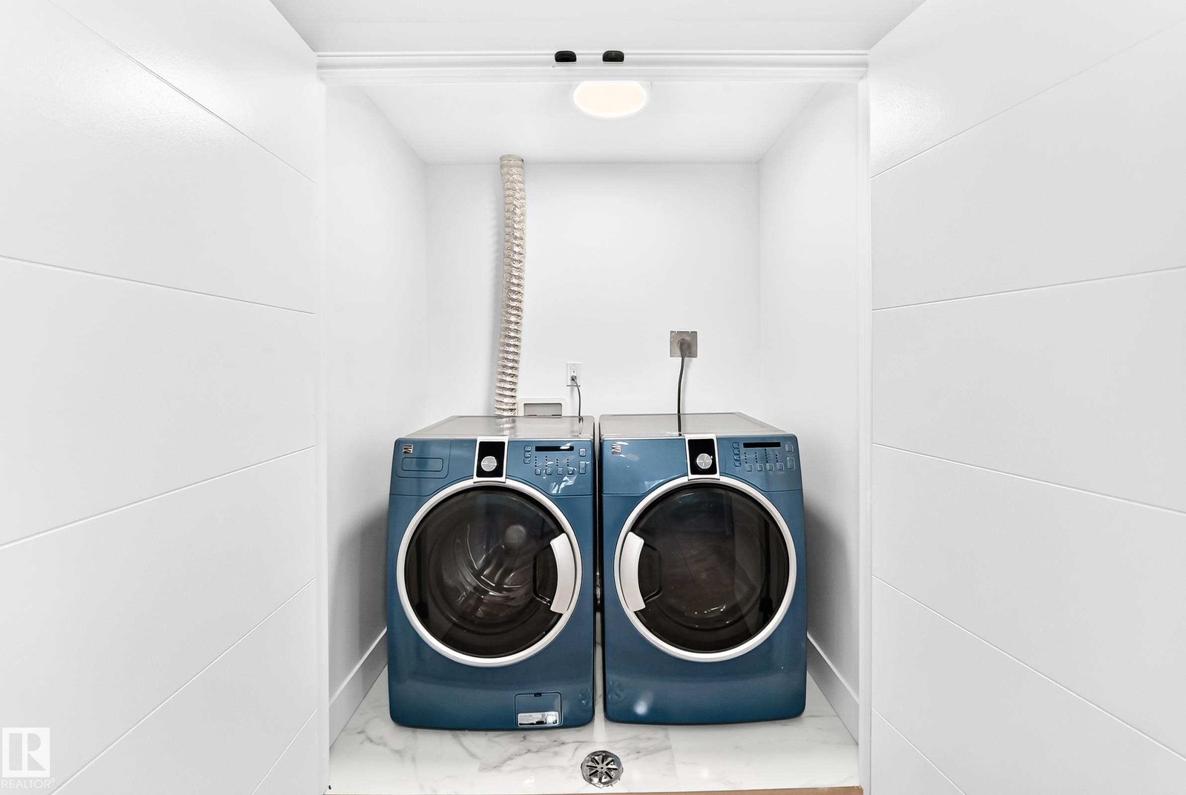 Compact laundry alcove featuring white shiplap walls and a tile floor - 3119 144 Avenue Nw, Edmonton, AB - Indoor Photo Showing Laundry Room