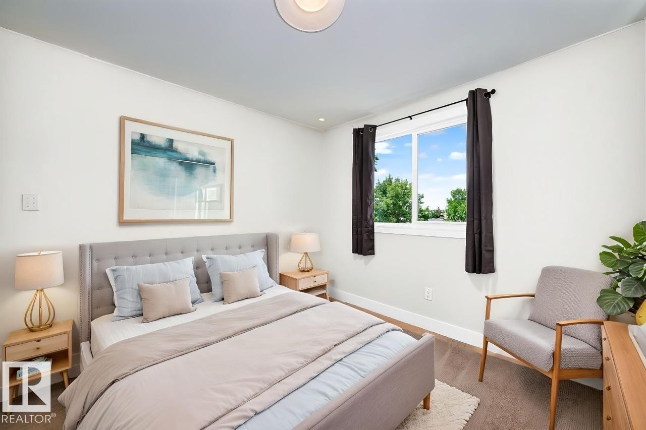 Bright bedroom featuring a large window, recessed lighting, and wood-finish flooring - 3119 144 Avenue Nw, Edmonton, AB - Indoor Photo Showing Bedroom