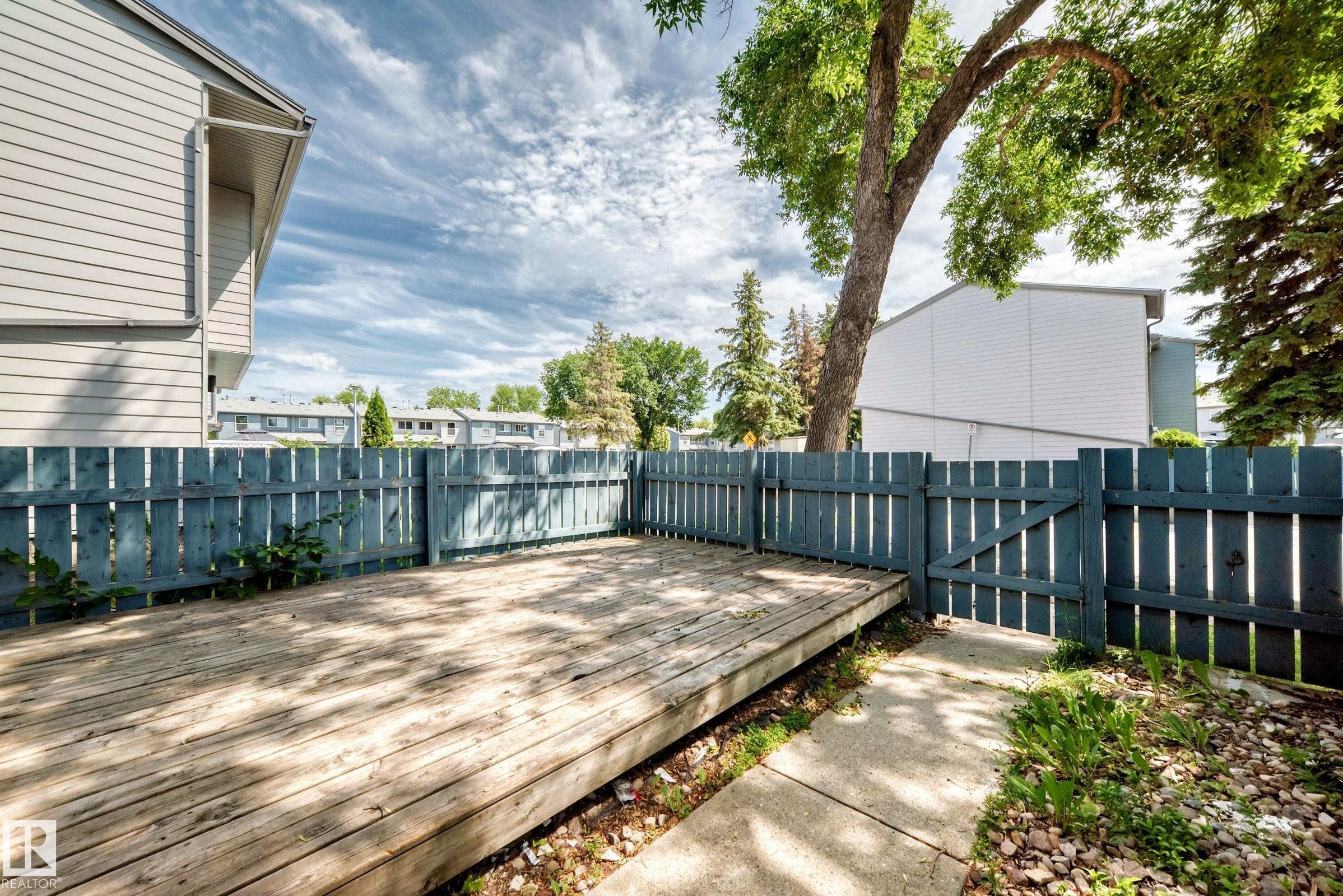 Expansive outdoor deck featuring wood planking and a surrounding privacy fence - 3119 144 Avenue Nw, Edmonton, AB - Outdoor With Deck Patio Veranda With Exterior
