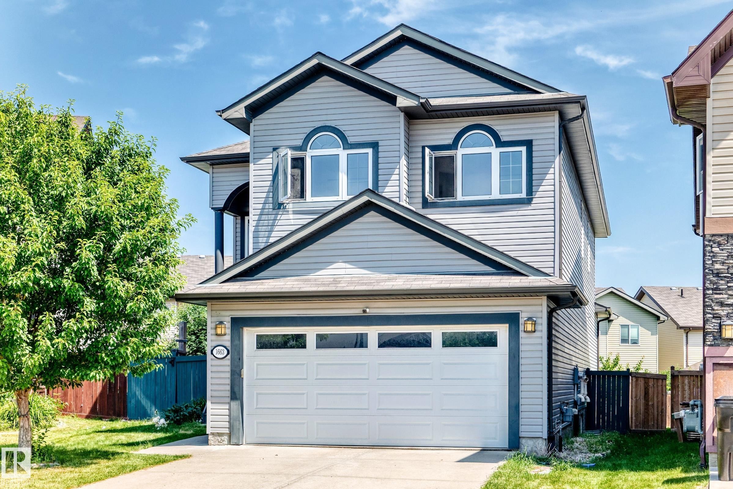 Two-story residential exterior featuring light gray horizontal siding and dark trim - 1663 Rutherford Road Sw, Edmonton, AB - Outdoor