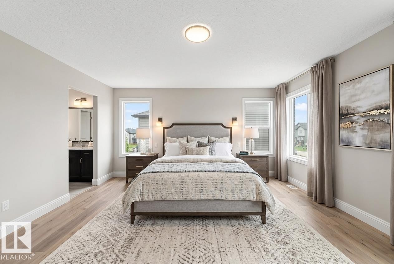 Spacious room featuring wood-finish flooring, light gray wall paint, and multiple windows with white blinds - 1663 Rutherford Road Sw, Edmonton, AB - Indoor Photo Showing Bedroom