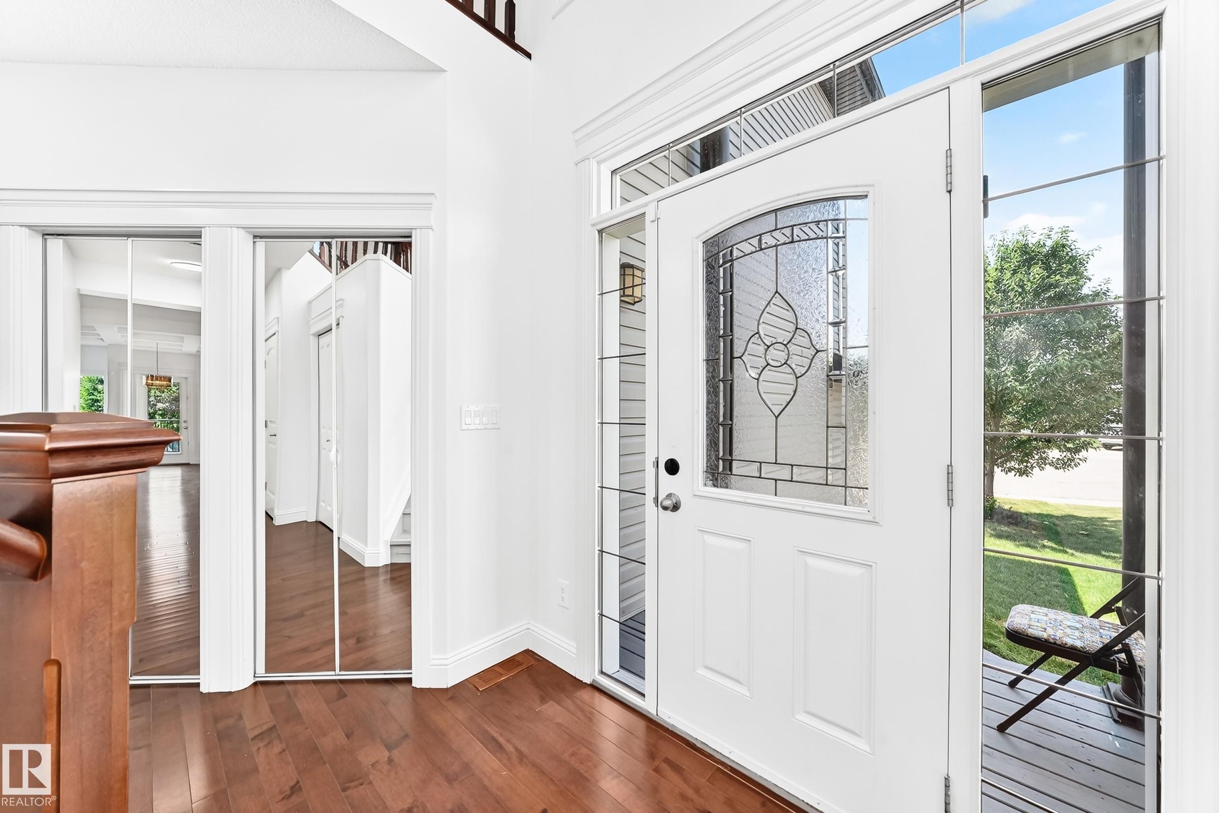 Entryway featuring a white door with decorative leaded glass, side light windows, and hardwood-finish flooring - 1663 Rutherford Road Sw, Edmonton, AB - Indoor Photo Showing Other Room