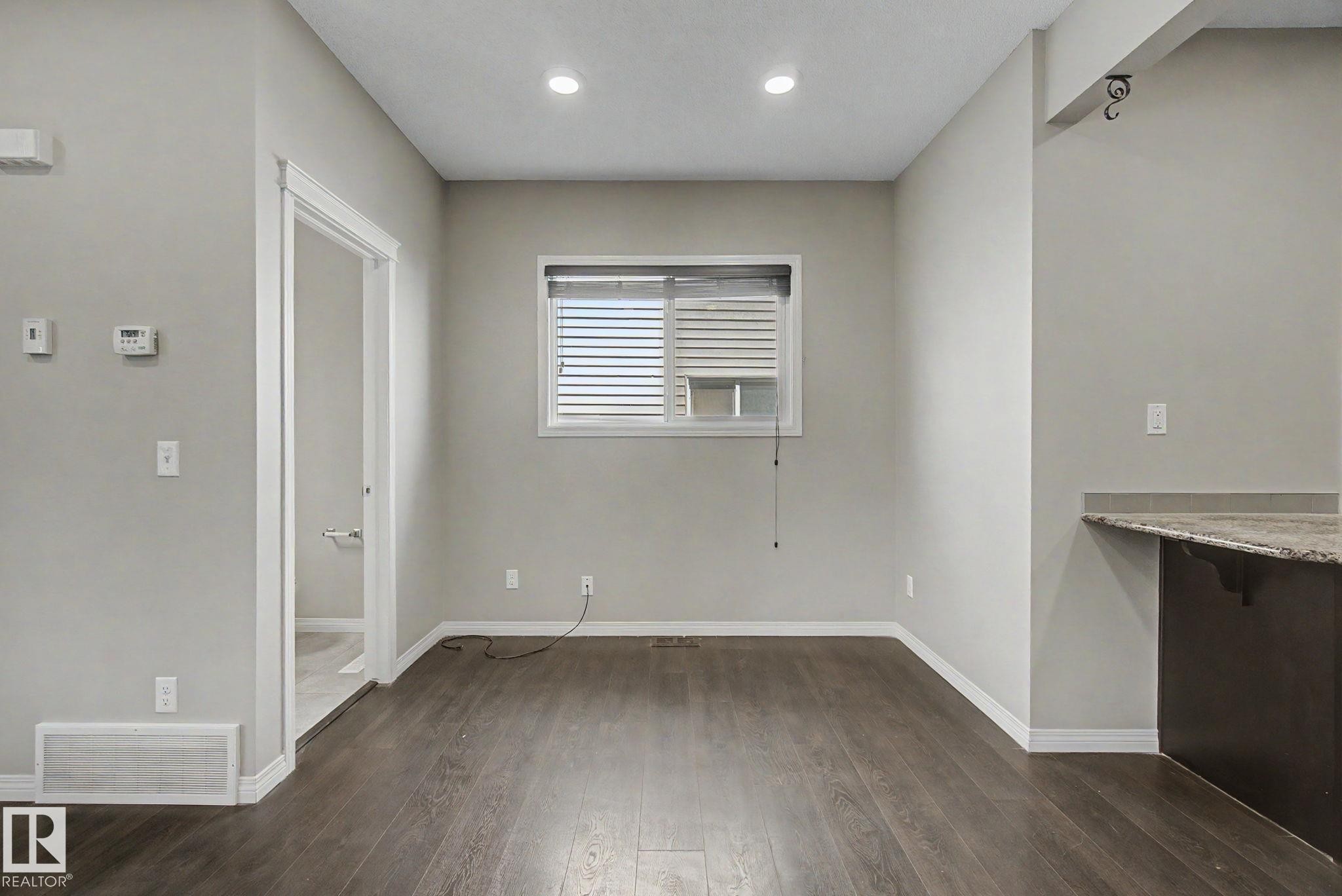 Open concept living space featuring wood-finish flooring, recessed lighting, and neutral wall tones - 315 Watt Boulevard Sw, Edmonton, AB - Indoor Photo Showing Other Room