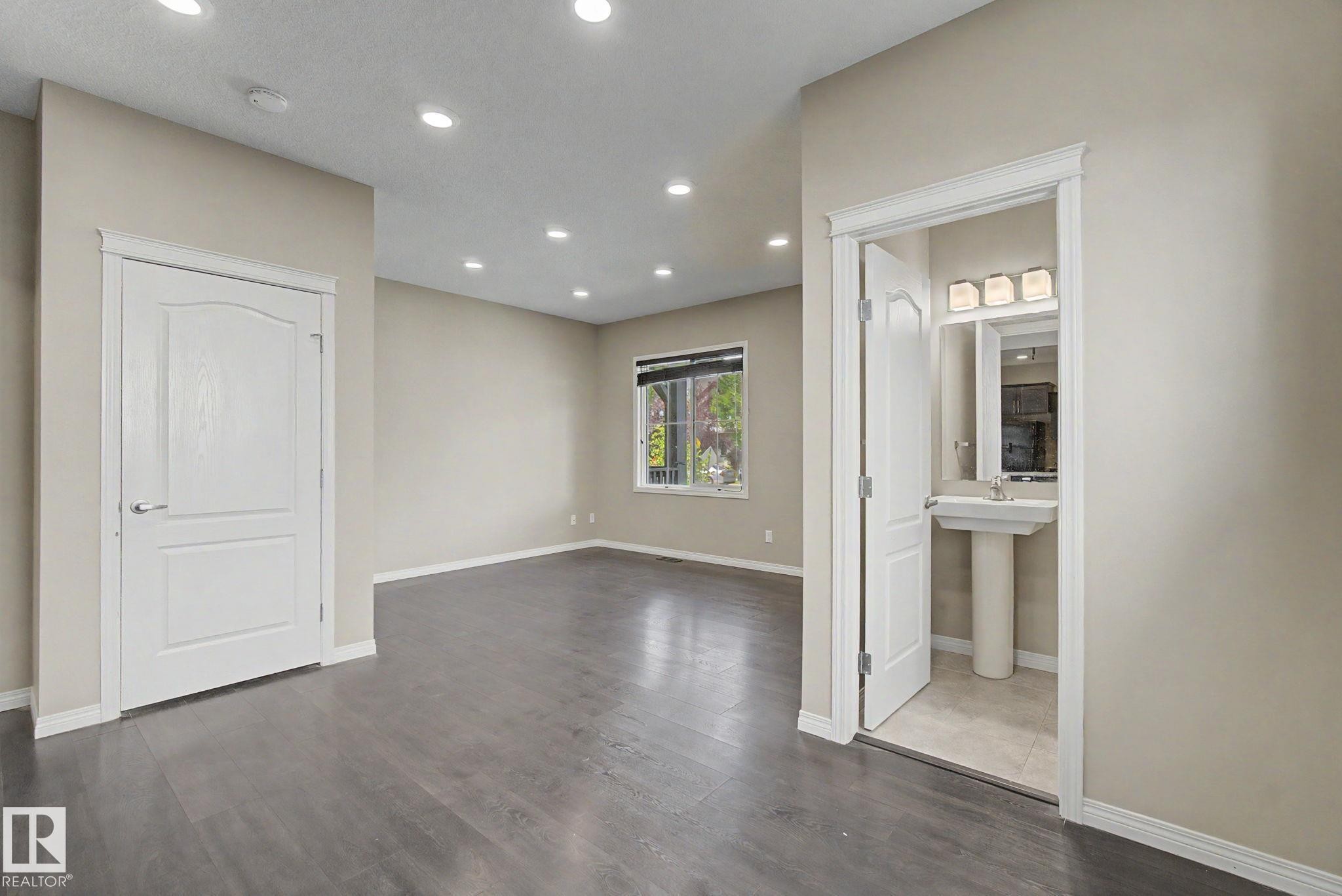 Bright interior space featuring wood-finish flooring, recessed lighting, and a neutral wall palette - 315 Watt Boulevard Sw, Edmonton, AB - Indoor Photo Showing Other Room