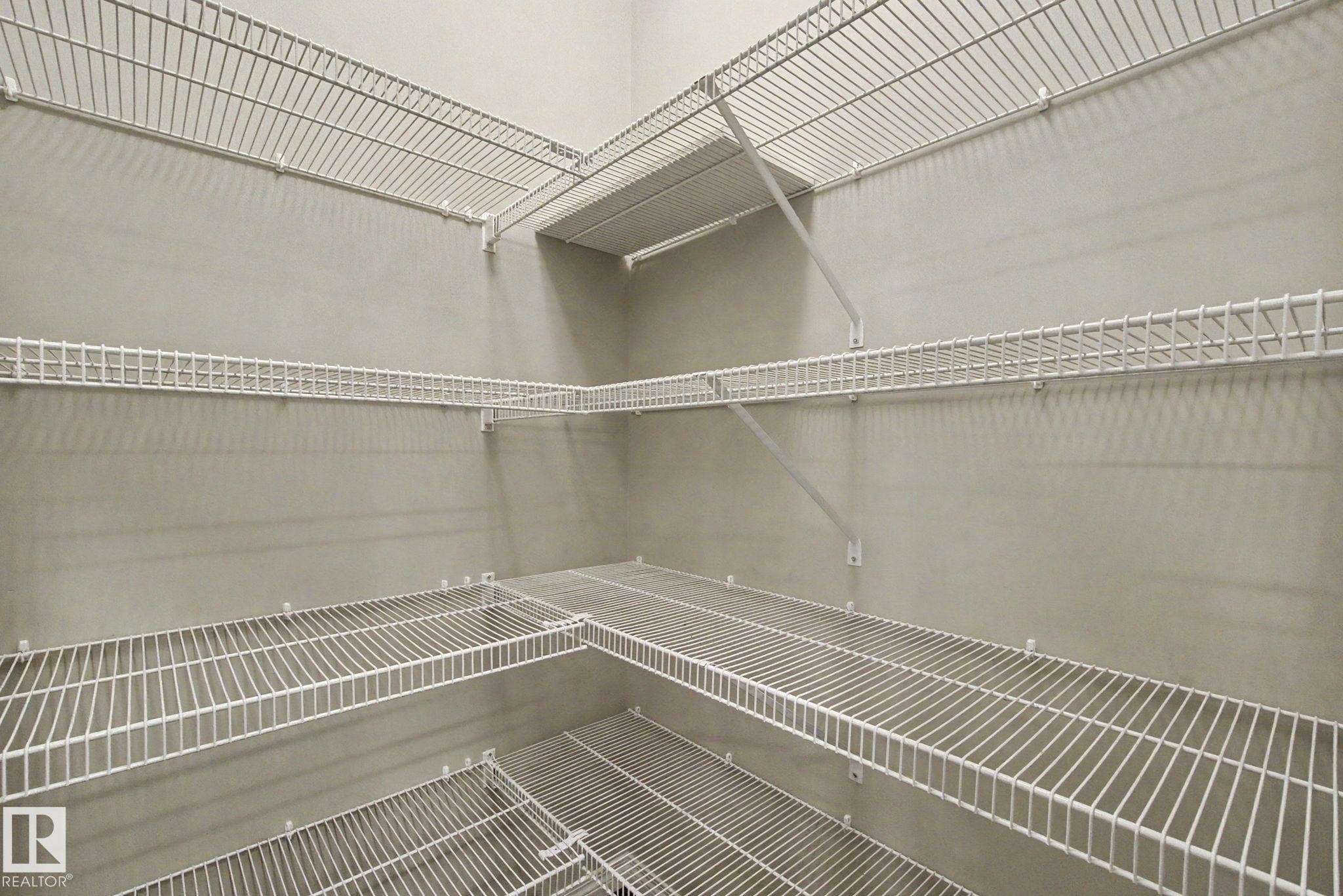 Expansive storage area featuring multiple tiers of white wire shelving, providing ample organizational solutions - 315 Watt Boulevard Sw, Edmonton, AB - Indoor With Storage