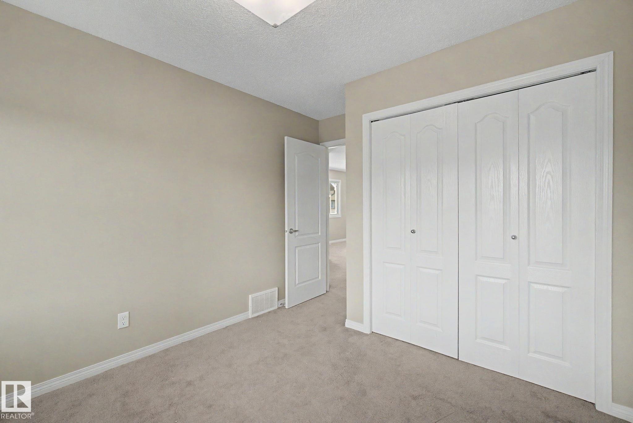 Room featuring light neutral wall paint, white baseboards, and wall-to-wall carpeting - 315 Watt Boulevard Sw, Edmonton, AB - Indoor