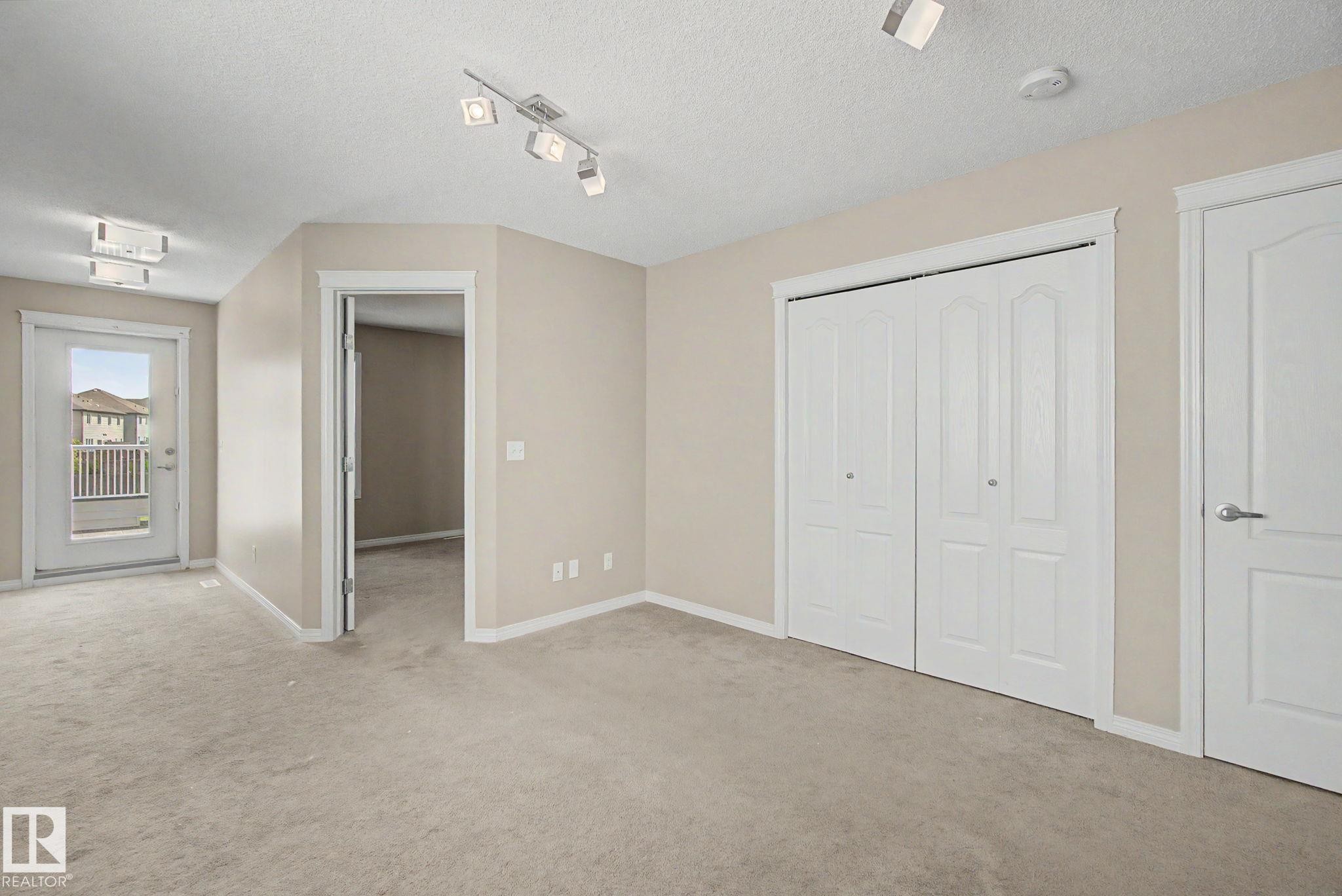 Carpeted room with neutral wall tones and a white bi-fold closet - 315 Watt Boulevard Sw, Edmonton, AB - Indoor