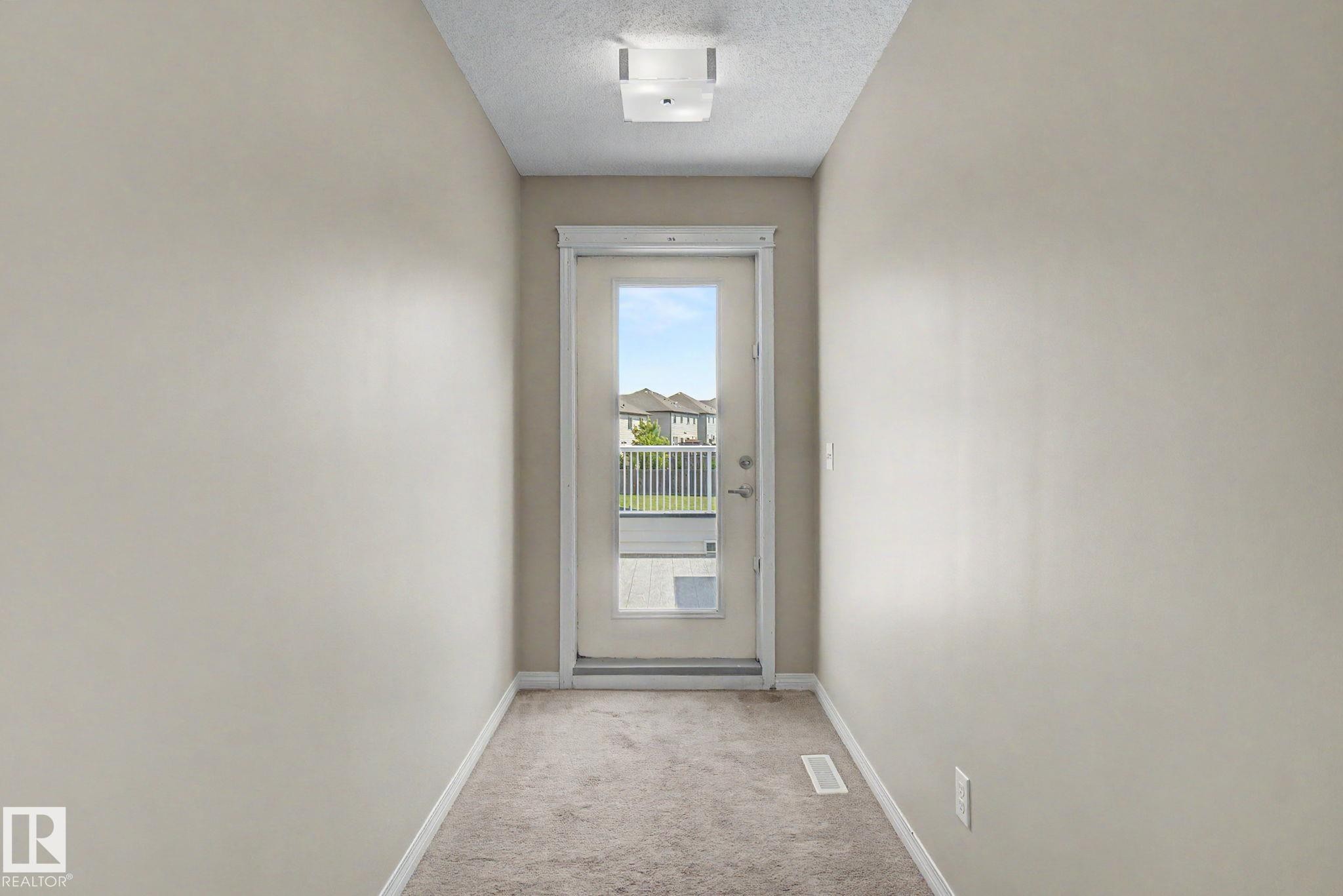 Rear exterior door with full glass panel and an interior transom window - 315 Watt Boulevard Sw, Edmonton, AB - Indoor Photo Showing Other Room